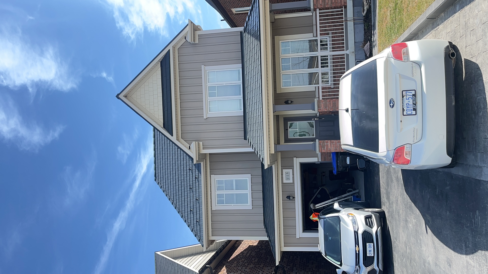 Two-storey Craftsman home in Innisfil ON with deep charcoal Interlock aluminum cedar shingle metal roofing on a steep multi-plane roof.