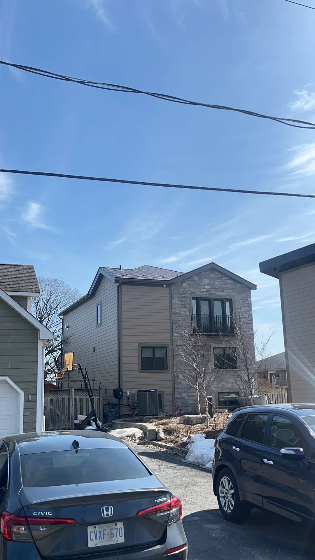 Tudor Brown Interlock Cedar Shingle aluminum roof on a Tudor style home with a metal roof in a suburban area, Innsifil, Ontario