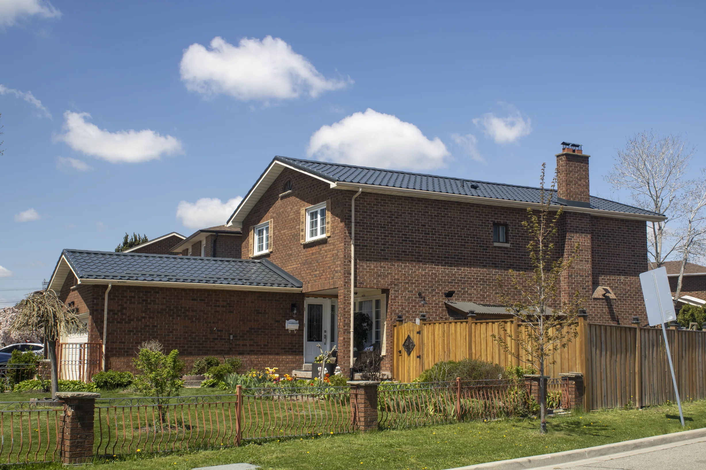 Deep Charcoal Interlock Tile aluminum roof on a two-storey home with a metal roof in Etobicoke, Ontario, Etobicoke, Ontario