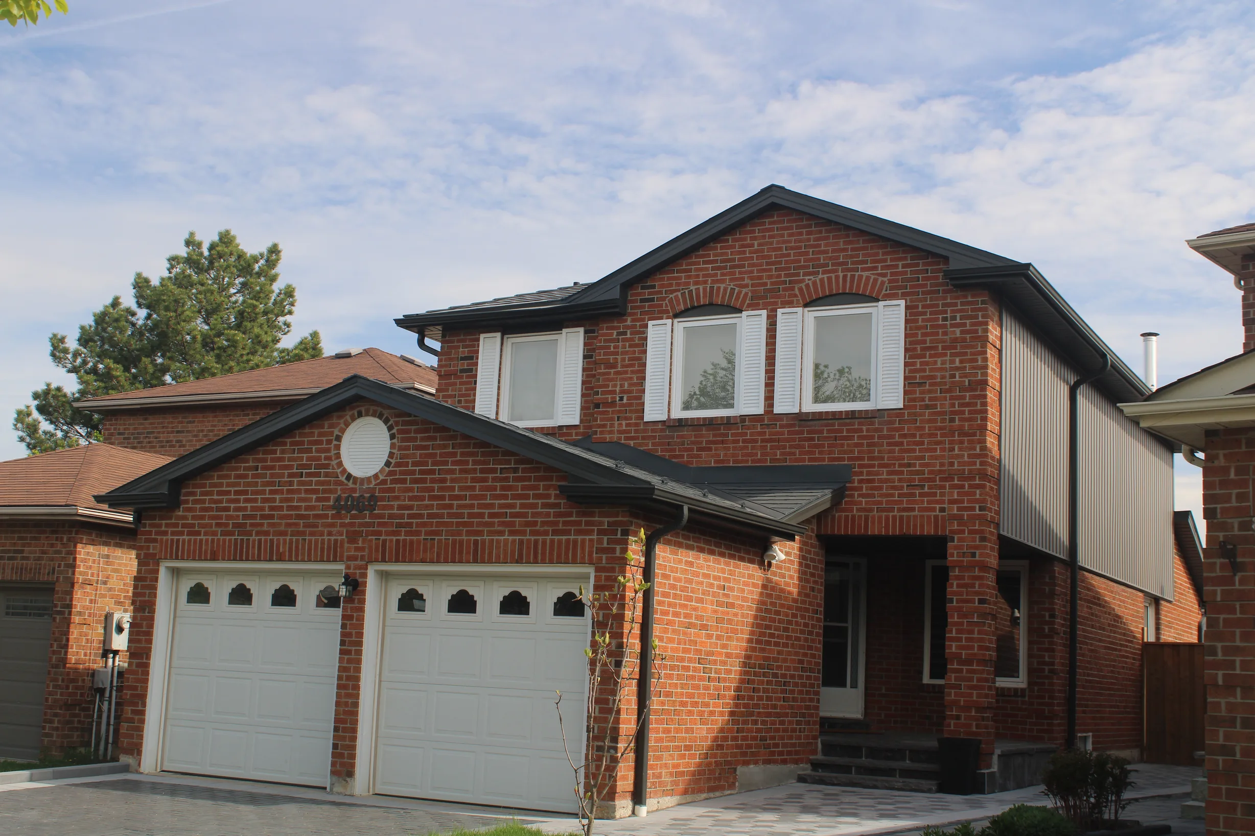 Deep Charcoal Interlock Slate aluminum roof on a red brick two-storey home with dormers in a suburban, Mississauga, Ontario