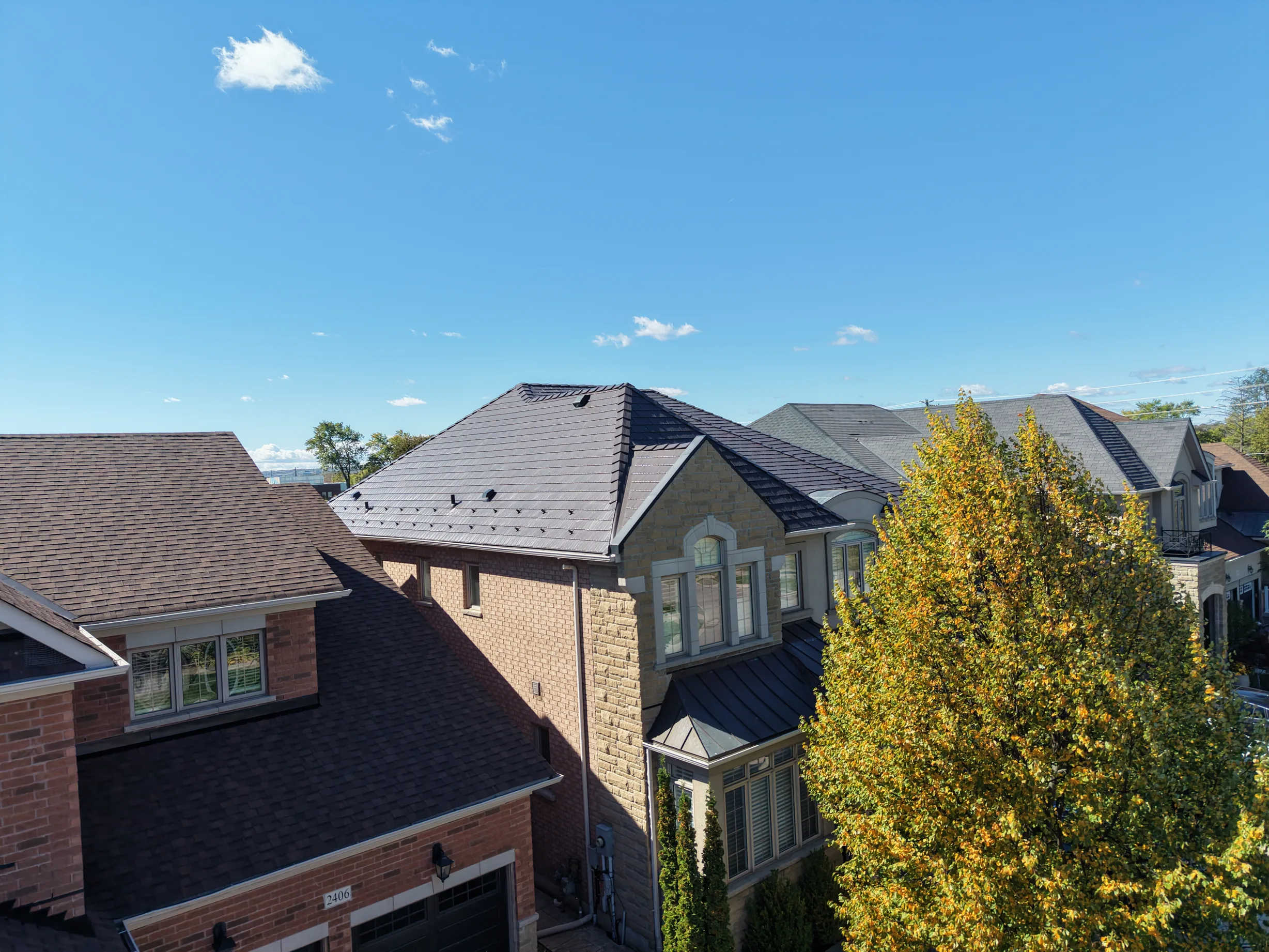 Tudor Brown Interlock Cedar Shingle aluminum roof on a brown two-storey home with dormers in a suburban setting, Oakville, Ontario