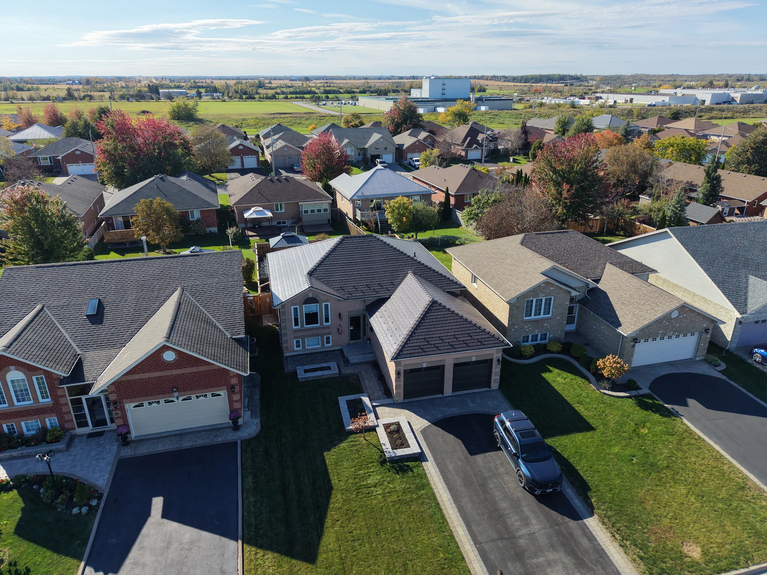 Tudor Brown Interlock Slate aluminum roof on a Tudor-style house with a brown metal roof in a rural area, Lindsay, Ontario