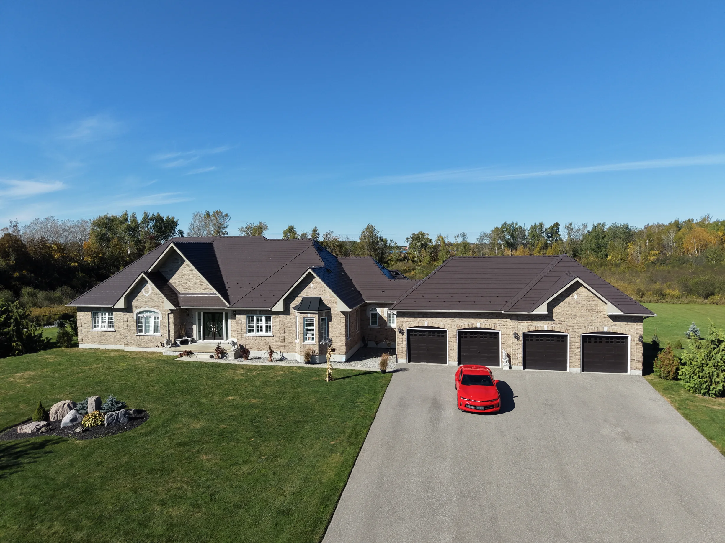Tudor Brown Interlock Slate aluminum roof on a Tudor home with a brown metal roof in a rural setting, Kawartha Lakes, Ontario