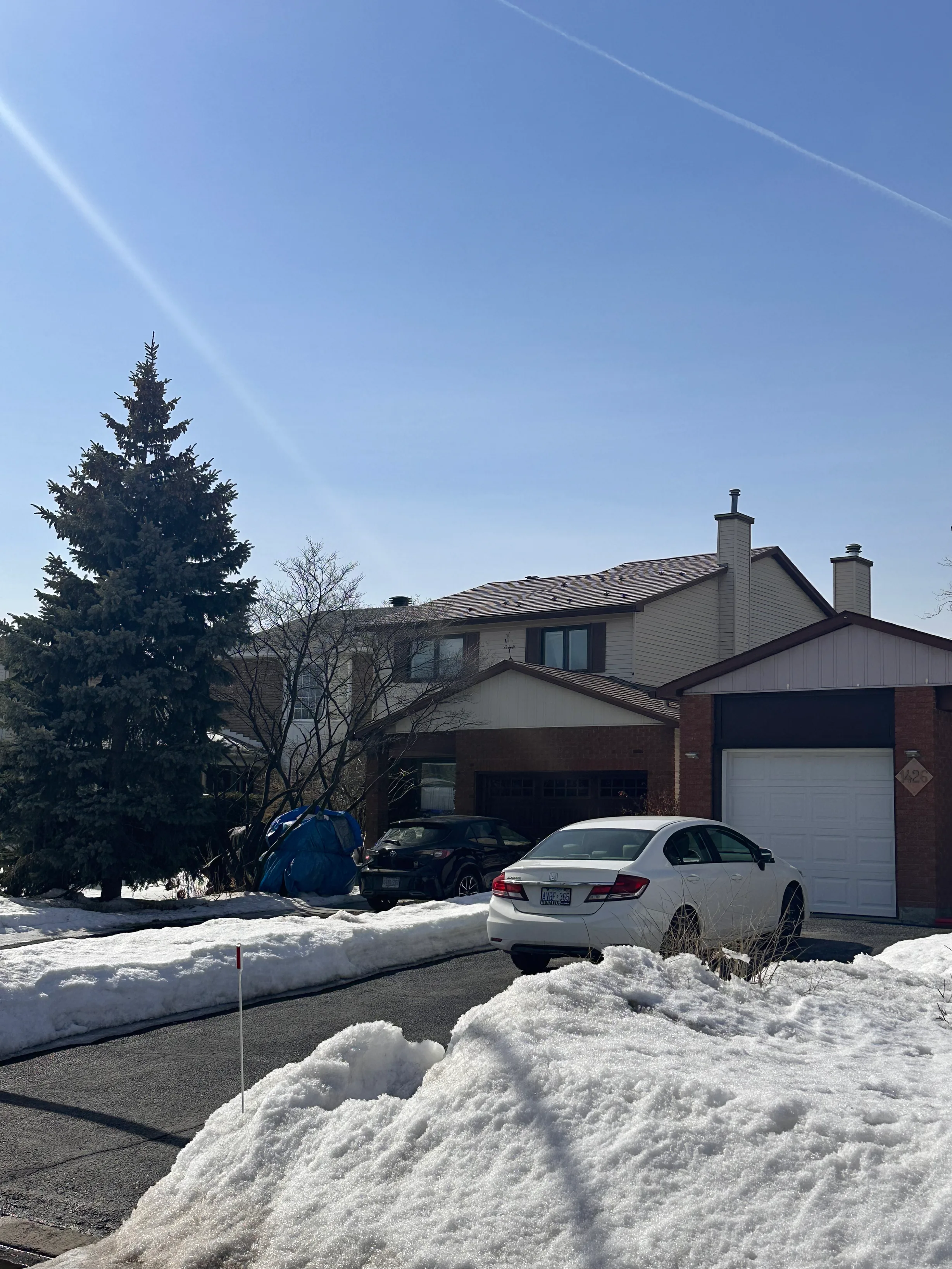 Aged Copper Interlock Shingle aluminum roof on a two-storey home with brown brick and beige siding in the, Gloucester, Ontario