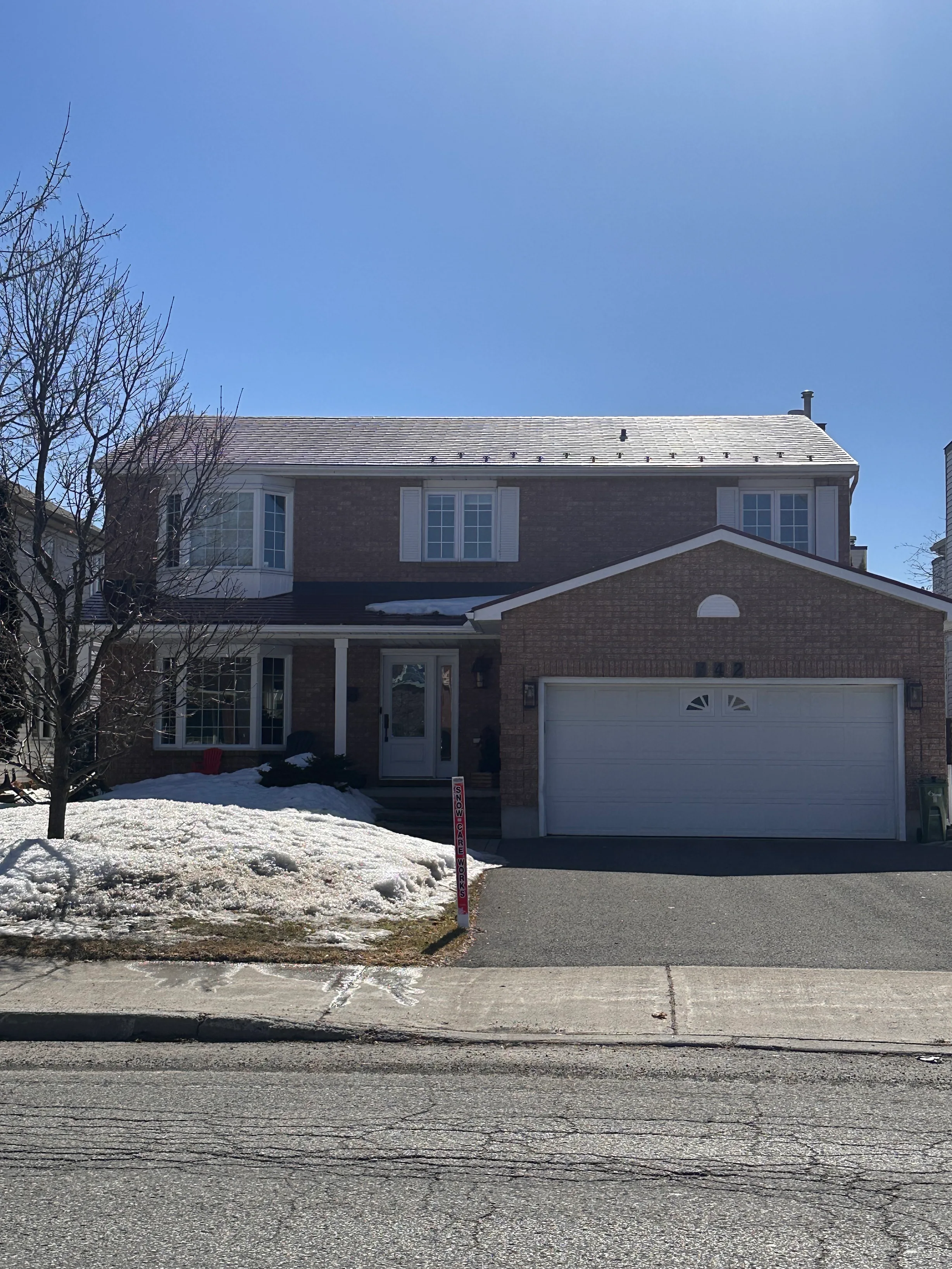 Tile Red Interlock Shingle aluminum roof on a red brick two-storey home with a metal roof in the suburbs, Orléans, Ontario