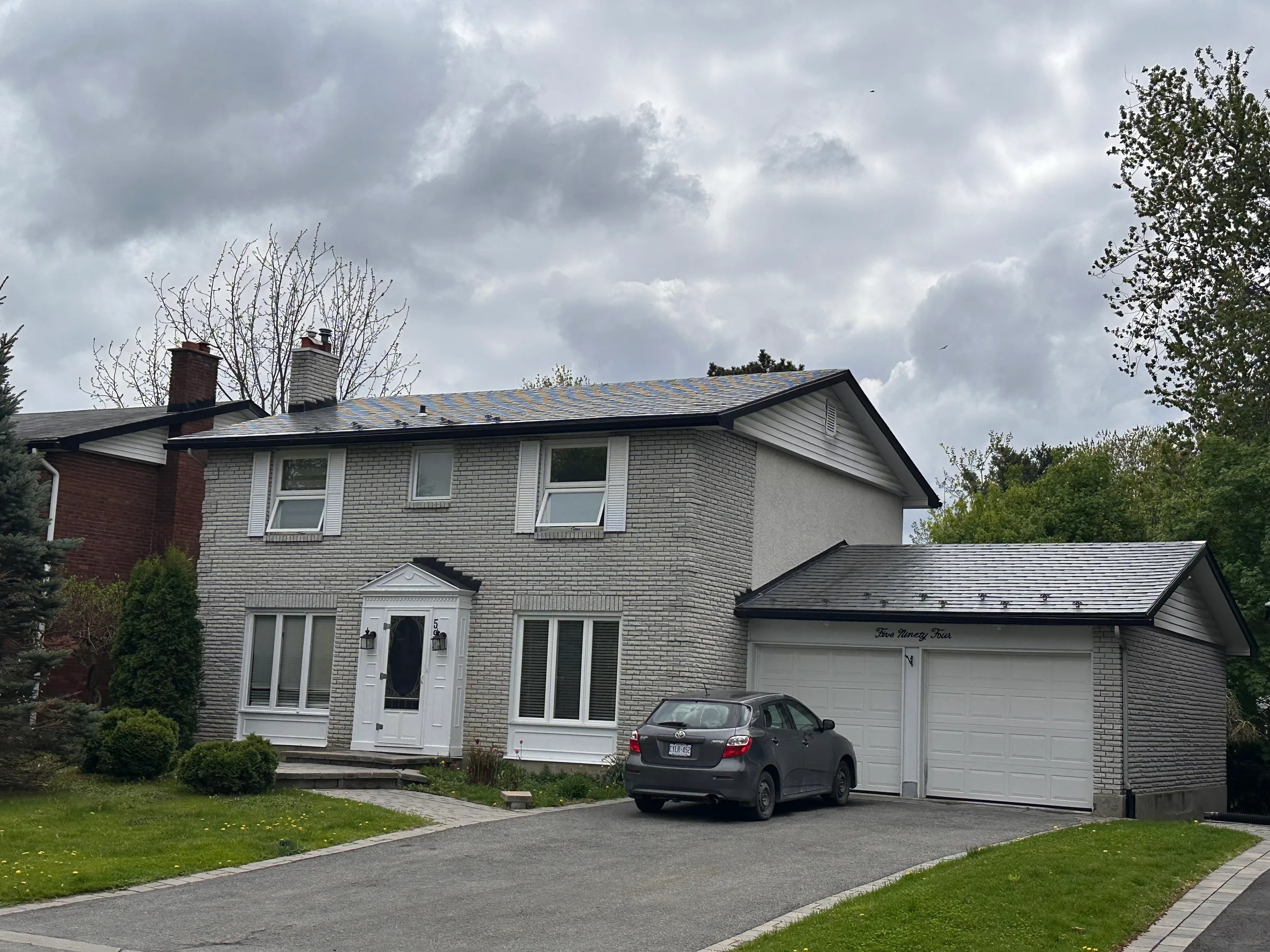 Colonial Brown Interlock Shingle aluminum roof on a Colonial brown metal roof on a two-storey house among, Ottawa, Ontario