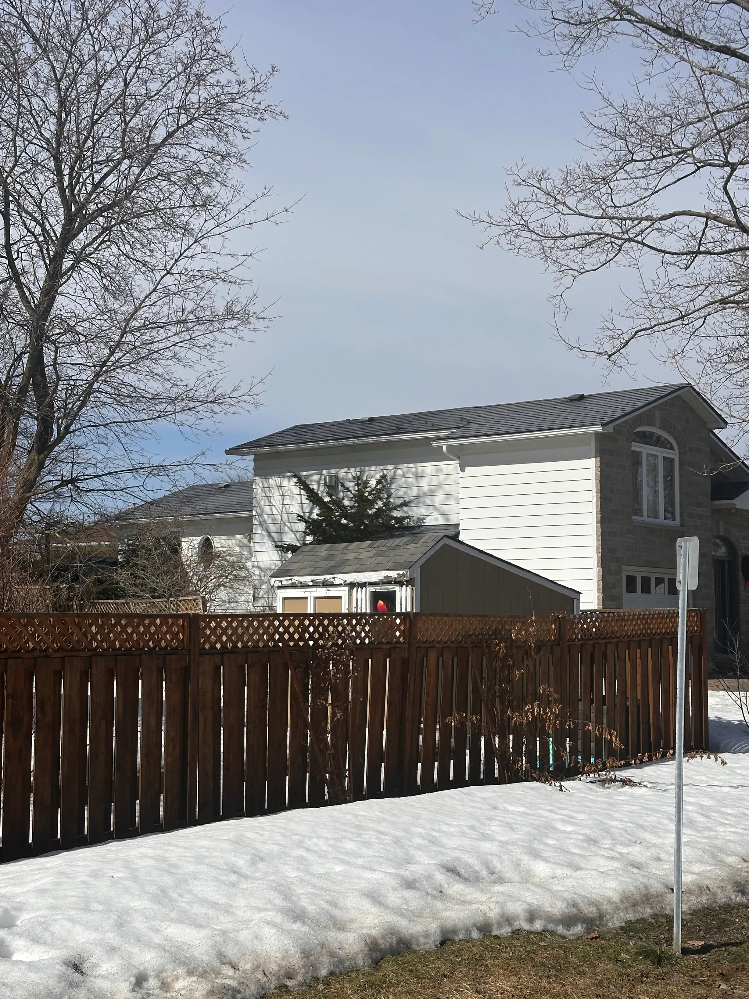 Charcoal Grey Interlock Shingle aluminum roof on a two-storey home with a grey metal roof and a snowy yard, Gloucester, Ontario