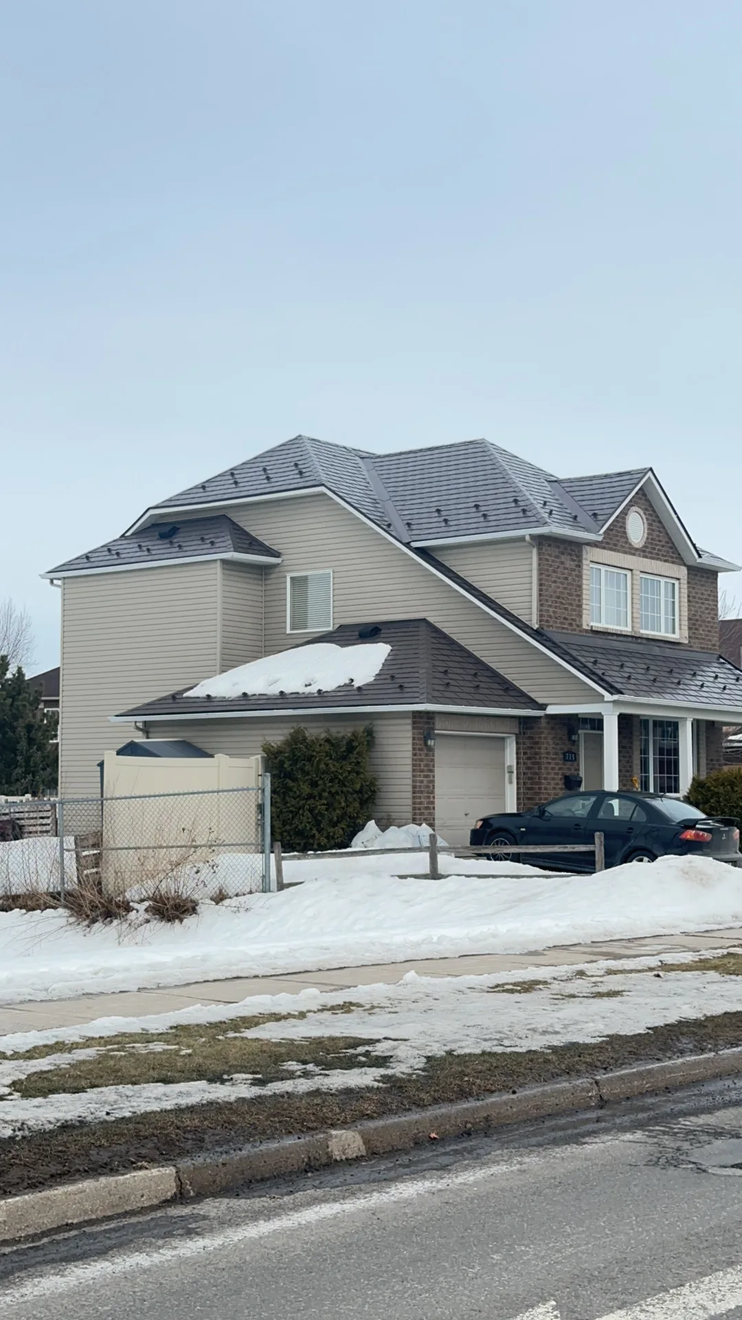 Tudor Brown Interlock Slate aluminum roof being installed on the home, replacing an asphalt shingle roof being torn off, Orléans, Ontario
