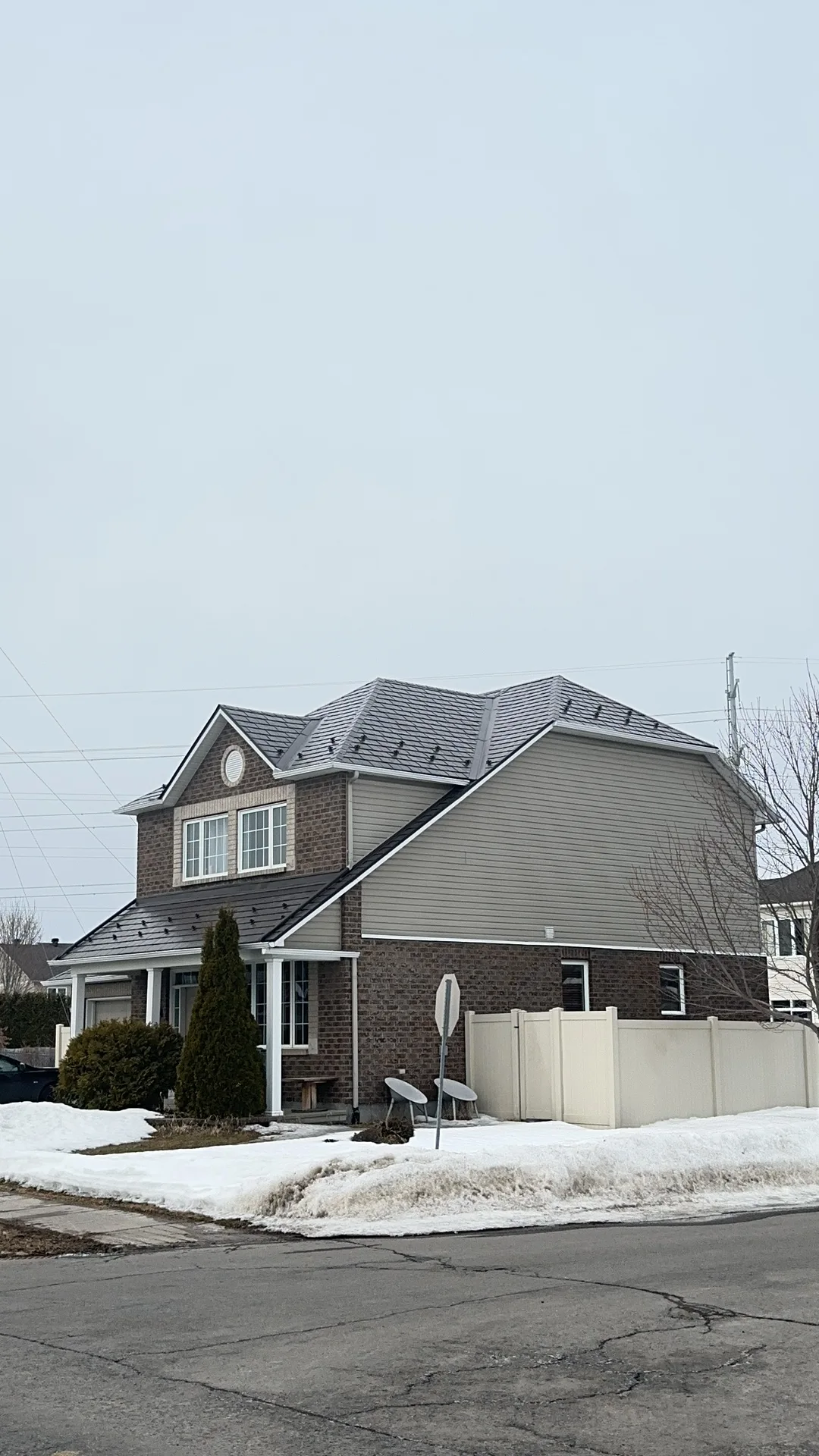 Tudor Brown Interlock Slate aluminum roof on a two-storey Tudor home with dormers in a suburban, Orléans, Ontario