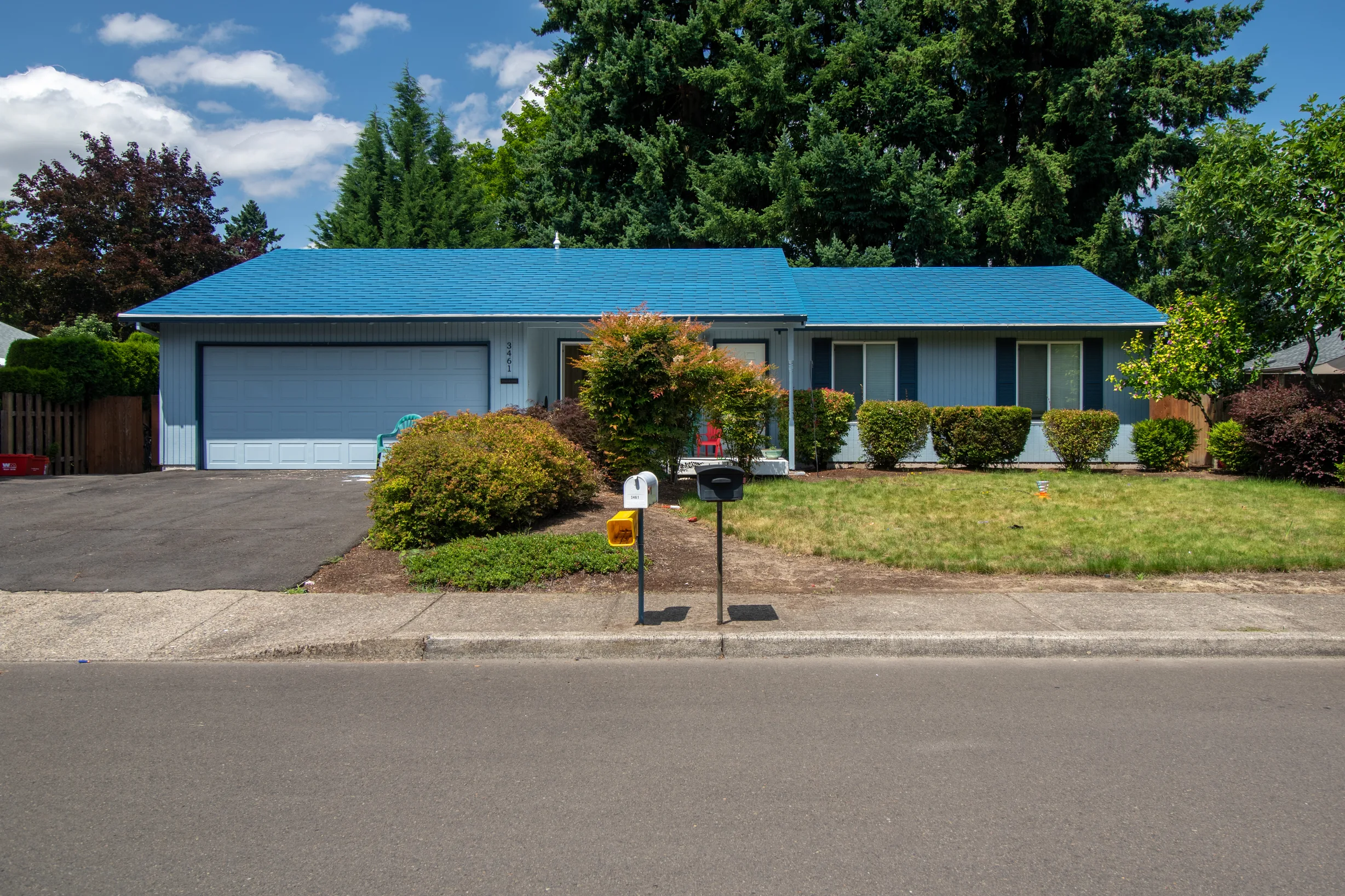Royal Blue Interlock Shingle aluminum roof on a blue ranch style home with a metal roof in a suburban, Hillsboro, Oregon