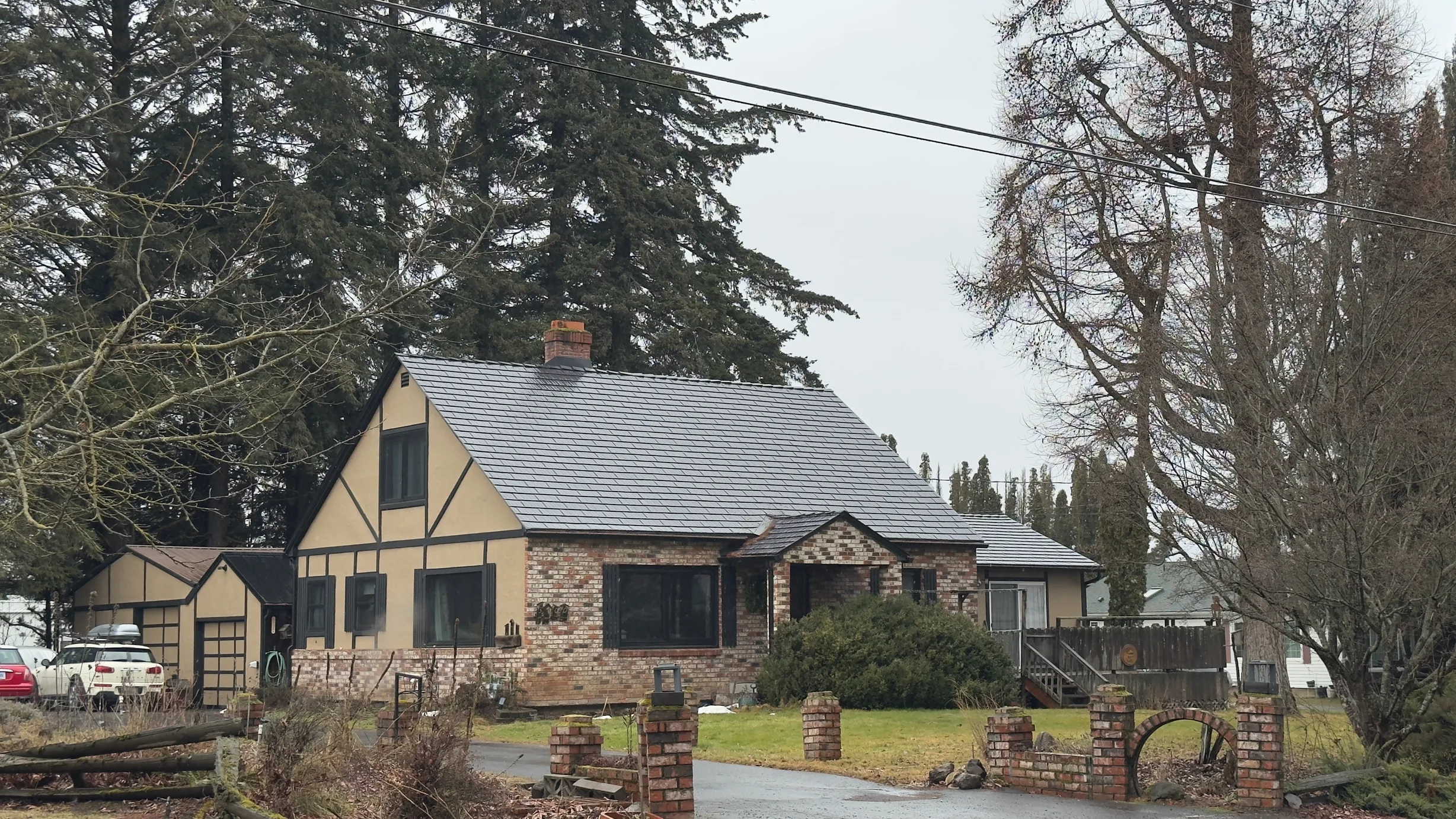 Black Interlock Cedar Shingle aluminum roof on a stone cottage with a metal roof in a rural mountain, Hood River, Oregon