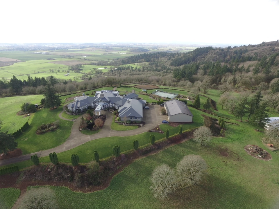 Deep Charcoal Interlock IB Membrane aluminum roof on a large home with a metal roof in a wooded rural setting, Turner, Oregon