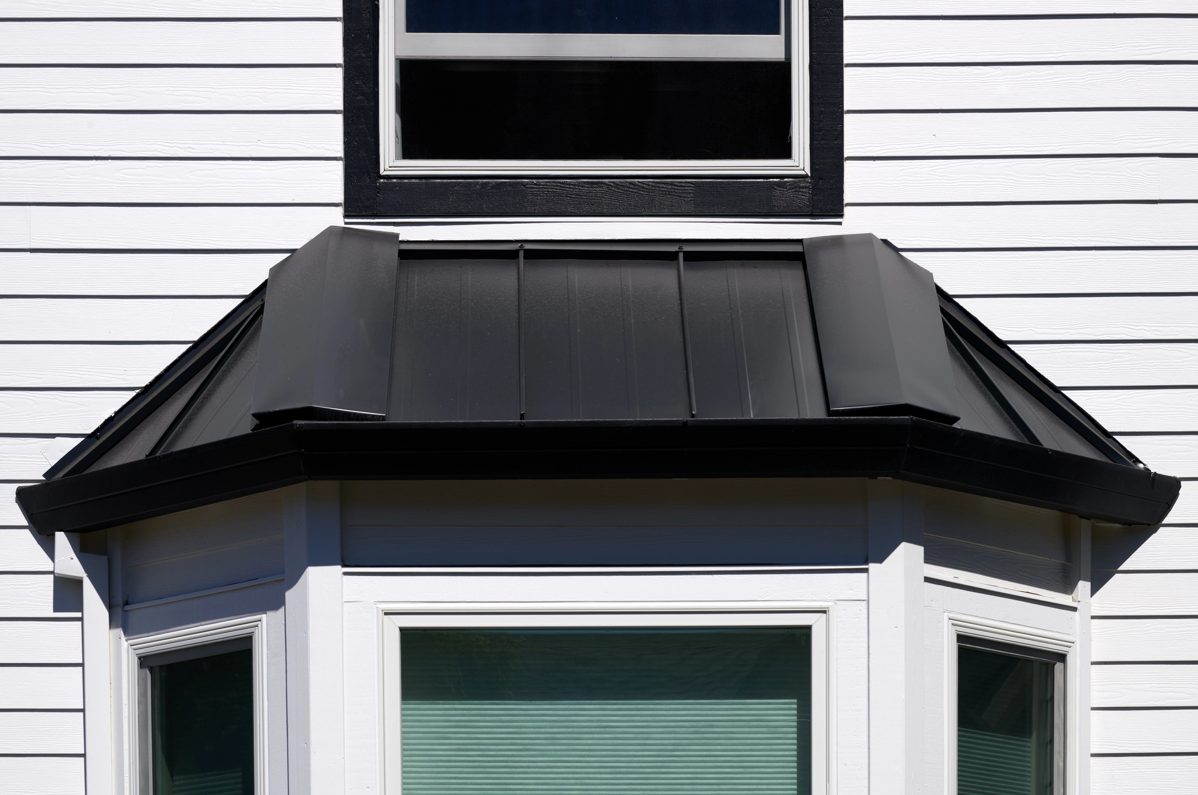Deep Charcoal Interlock Shake aluminum roof on a Deep Charcoal Interlock Shake metal roof on a white, Portland, Oregon