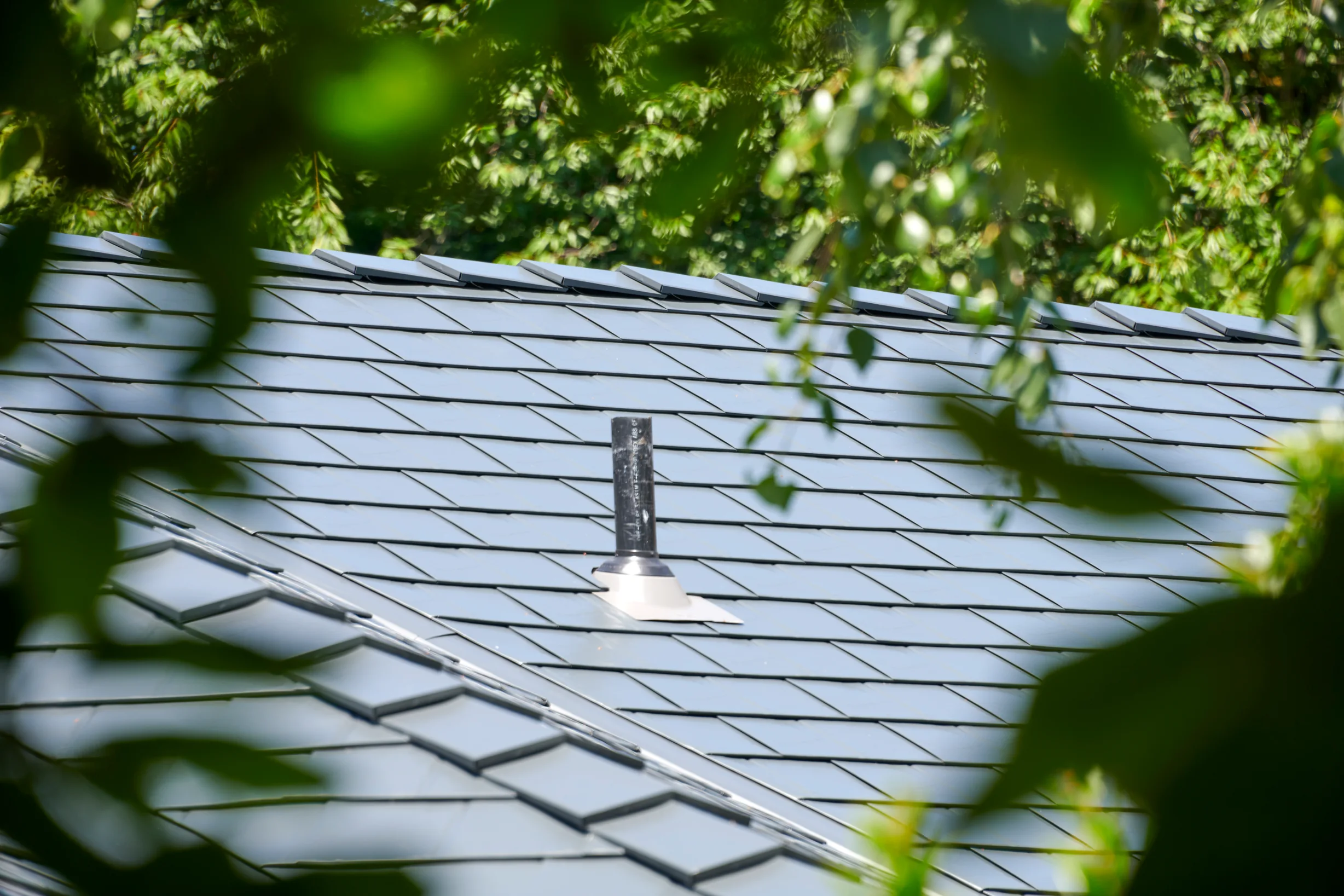 Deep Charcoal Interlock Slate aluminum roof on a modern home with a Deep Charcoal metal roof in a forested, Portland, Oregon