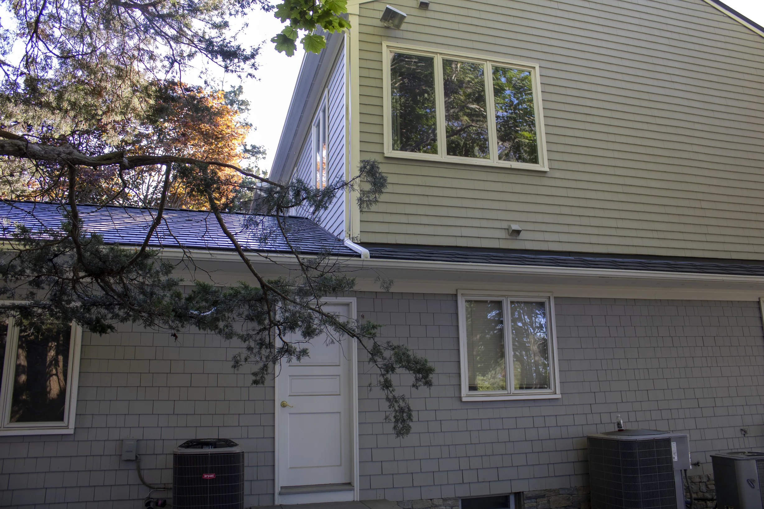 Deep Charcoal Interlock Slate aluminum roof on a colonial home with a metal roof in progress in a forest, Warwick, Rhode Island