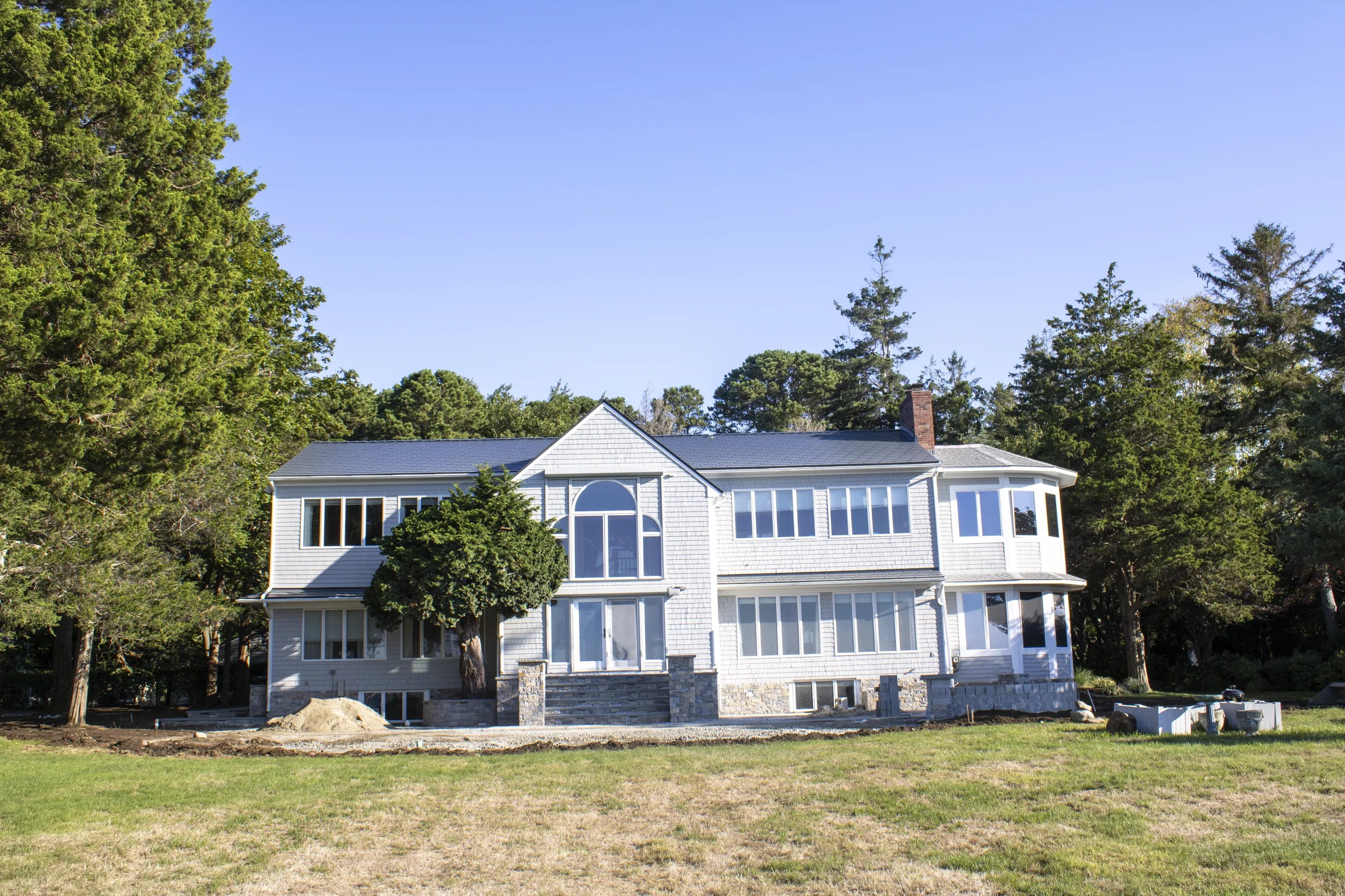 Deep Charcoal Interlock Slate aluminum roof on a grey two-storey home with dormers on a rural property, Warwick, Rhode Island