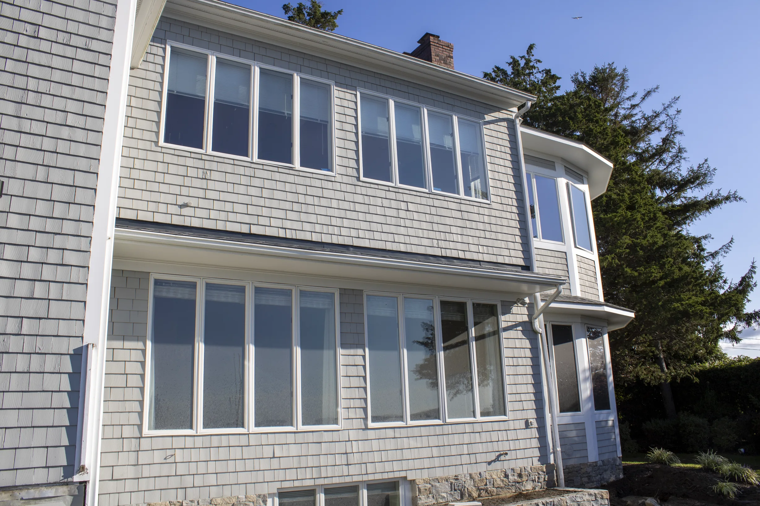 Deep Charcoal Interlock Slate aluminum roof on a two-storey Colonial home with a Deep Charcoal metal roof, Warwick, Rhode Island