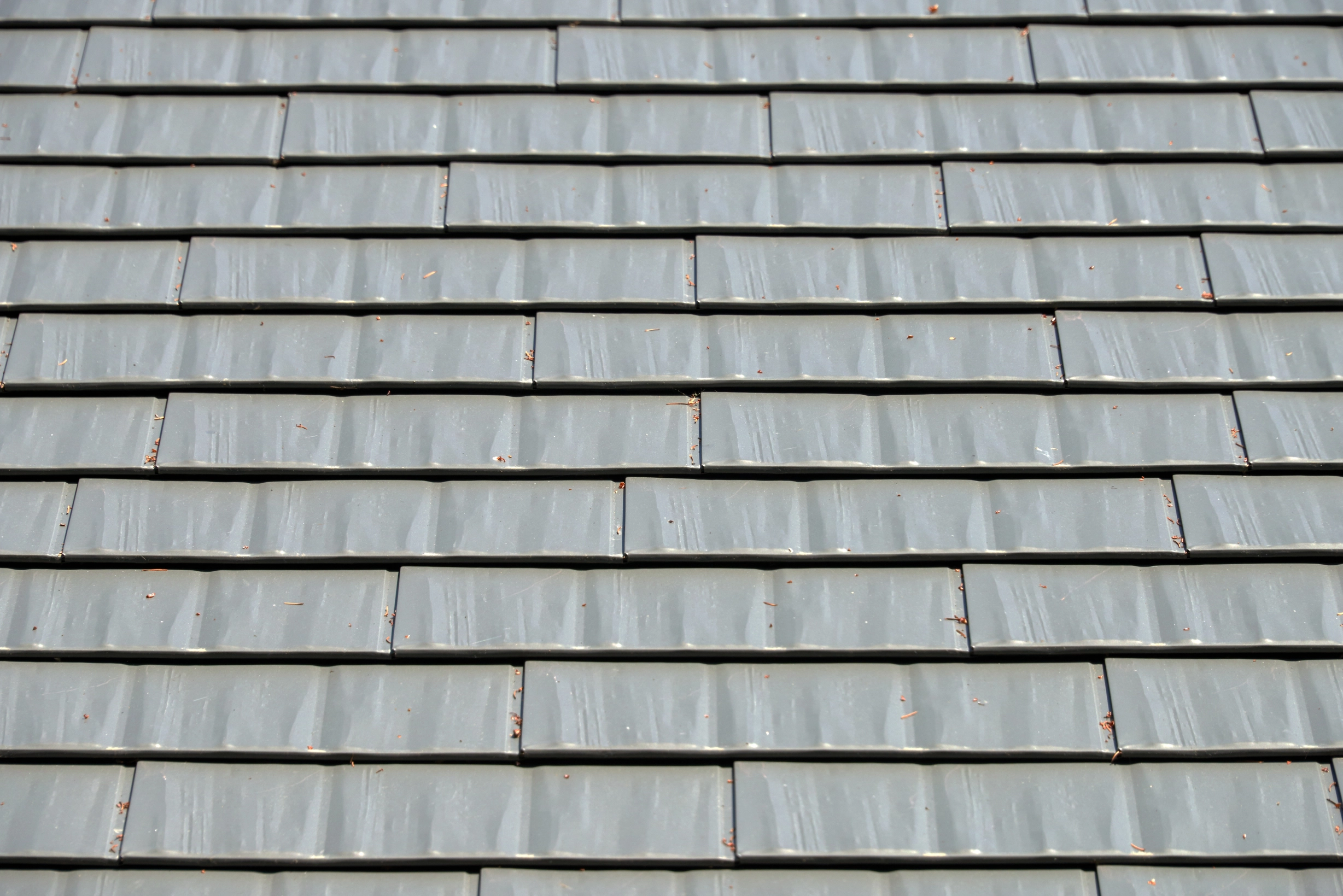 Musket Grey Interlock Cedar Shingle aluminum roof on a grey two-storey home with a metal roof in a suburban, Arlington, Washington