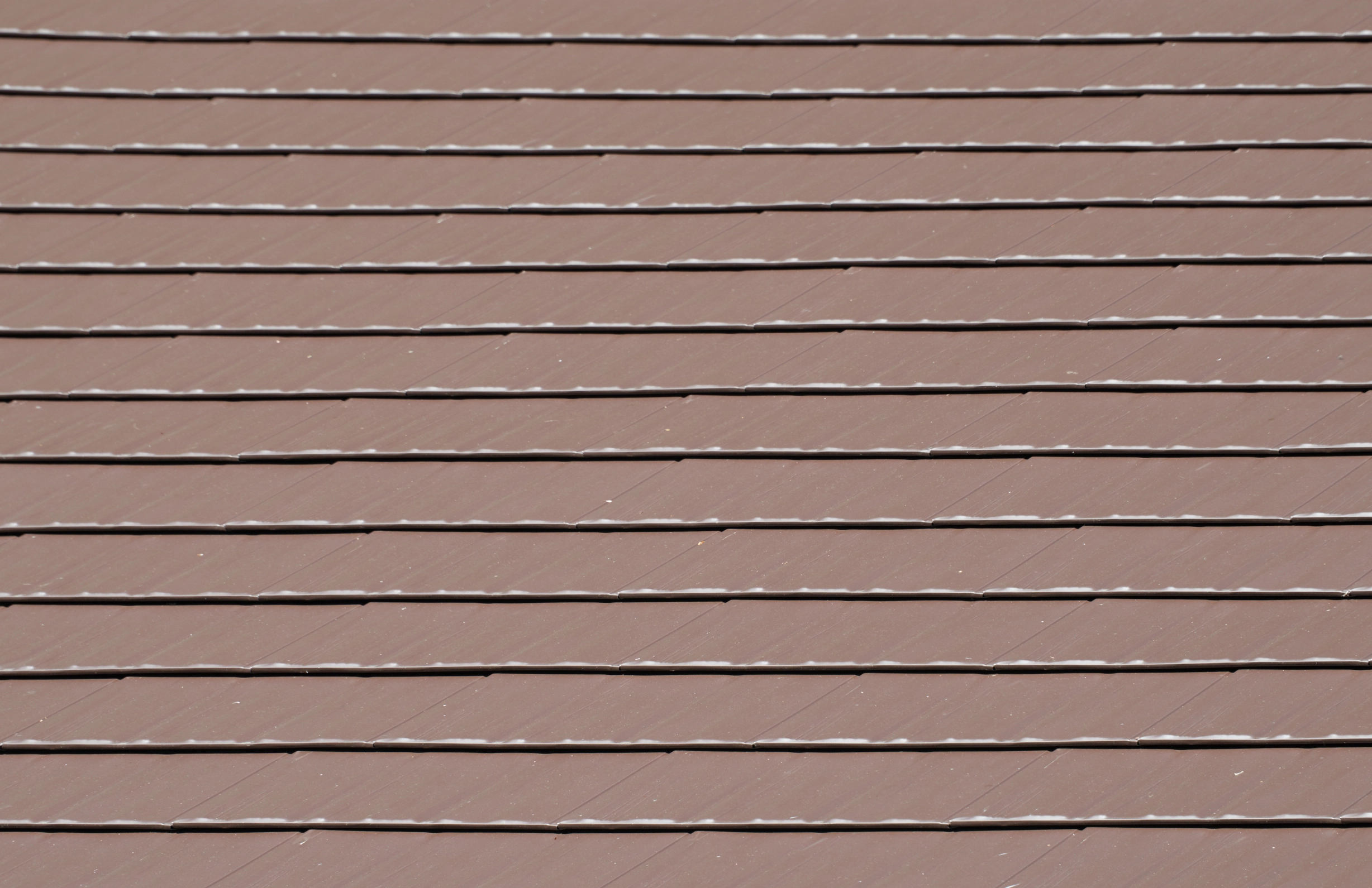 Colonial Brown Interlock Cedar Shingle aluminum roof on a Colonial brown single-family home with two stories among, Shoreline, Washington