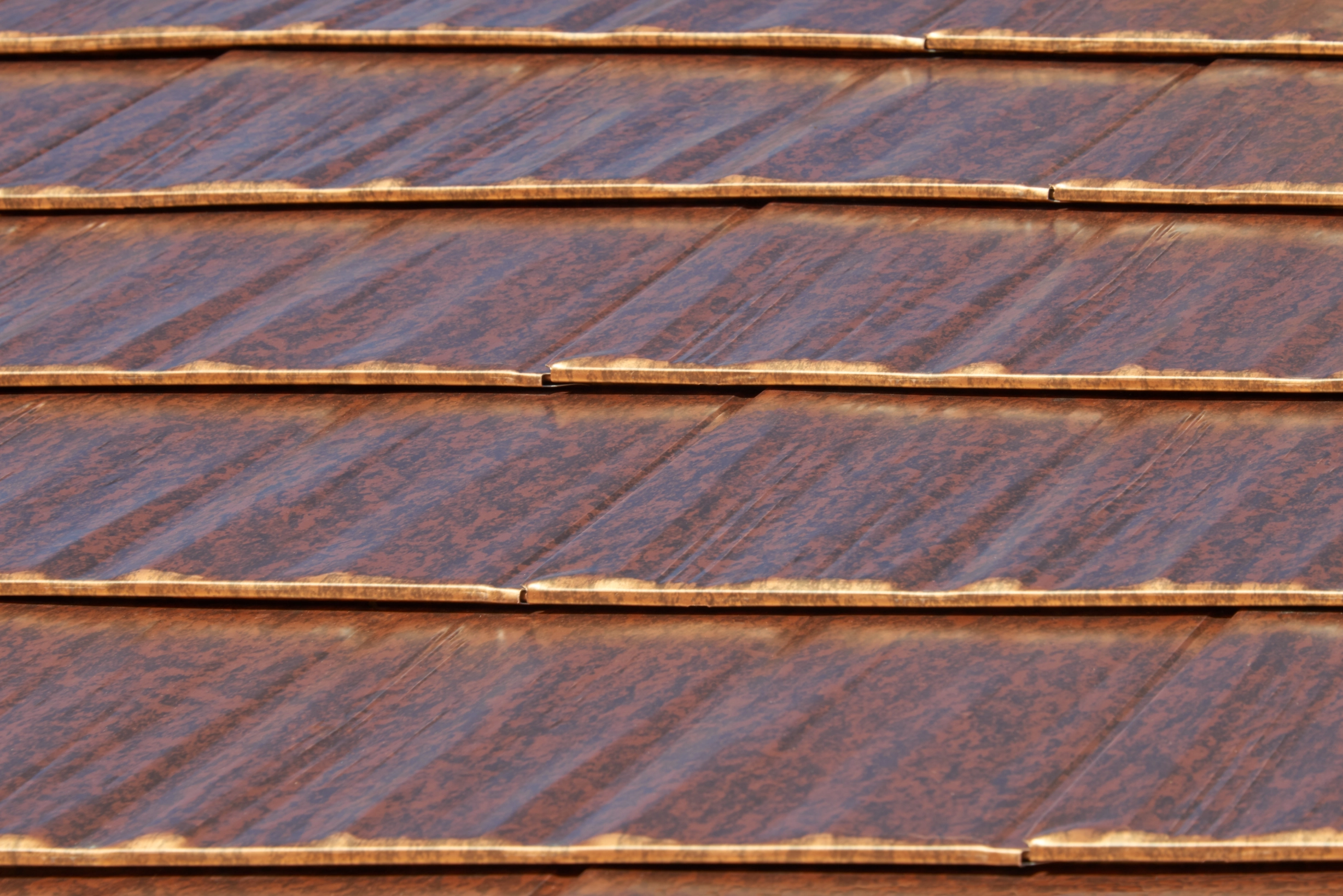 Aged Copper Interlock Cedar Shingle aluminum roof on a modern home with a metal roof in a lush green urban, Burien, Washington