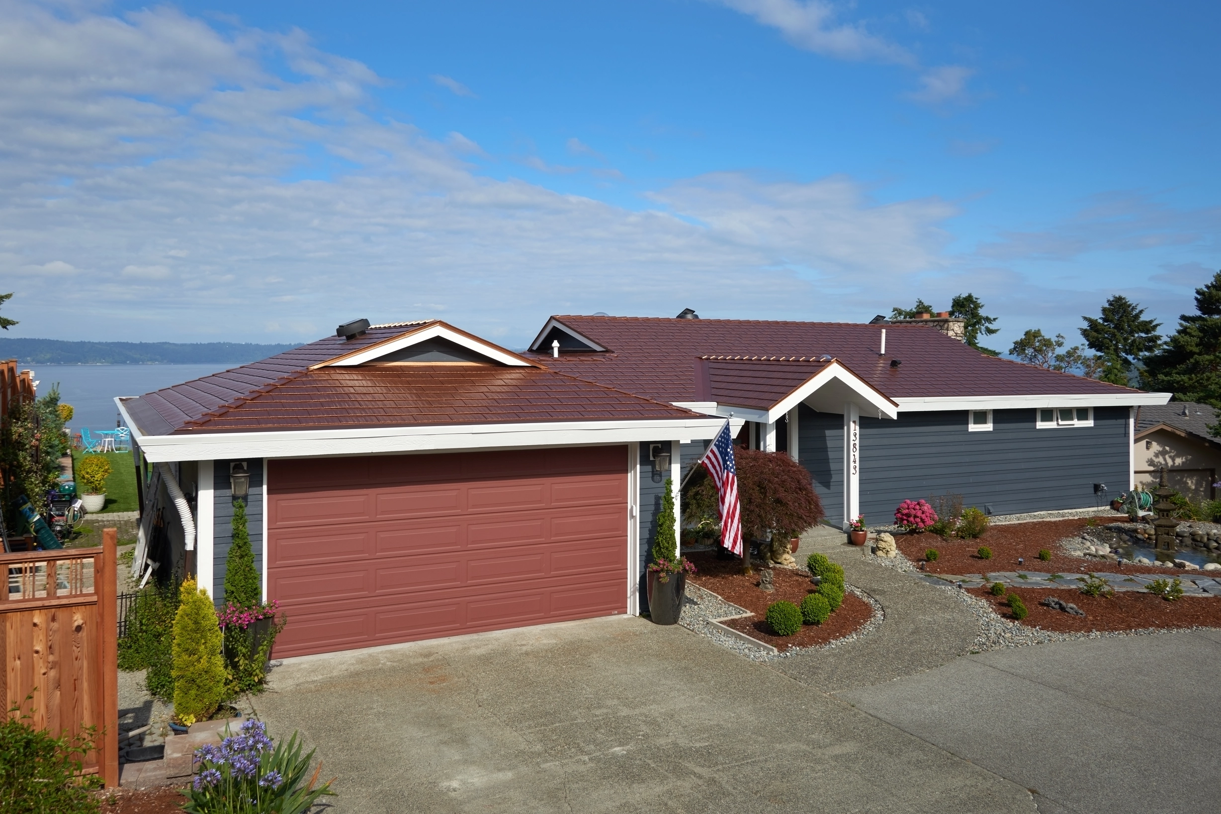 Aged Copper Interlock Cedar Shingle aluminum roof on a red ranch home with a metal roof overlooking a lake, Burien, Washington