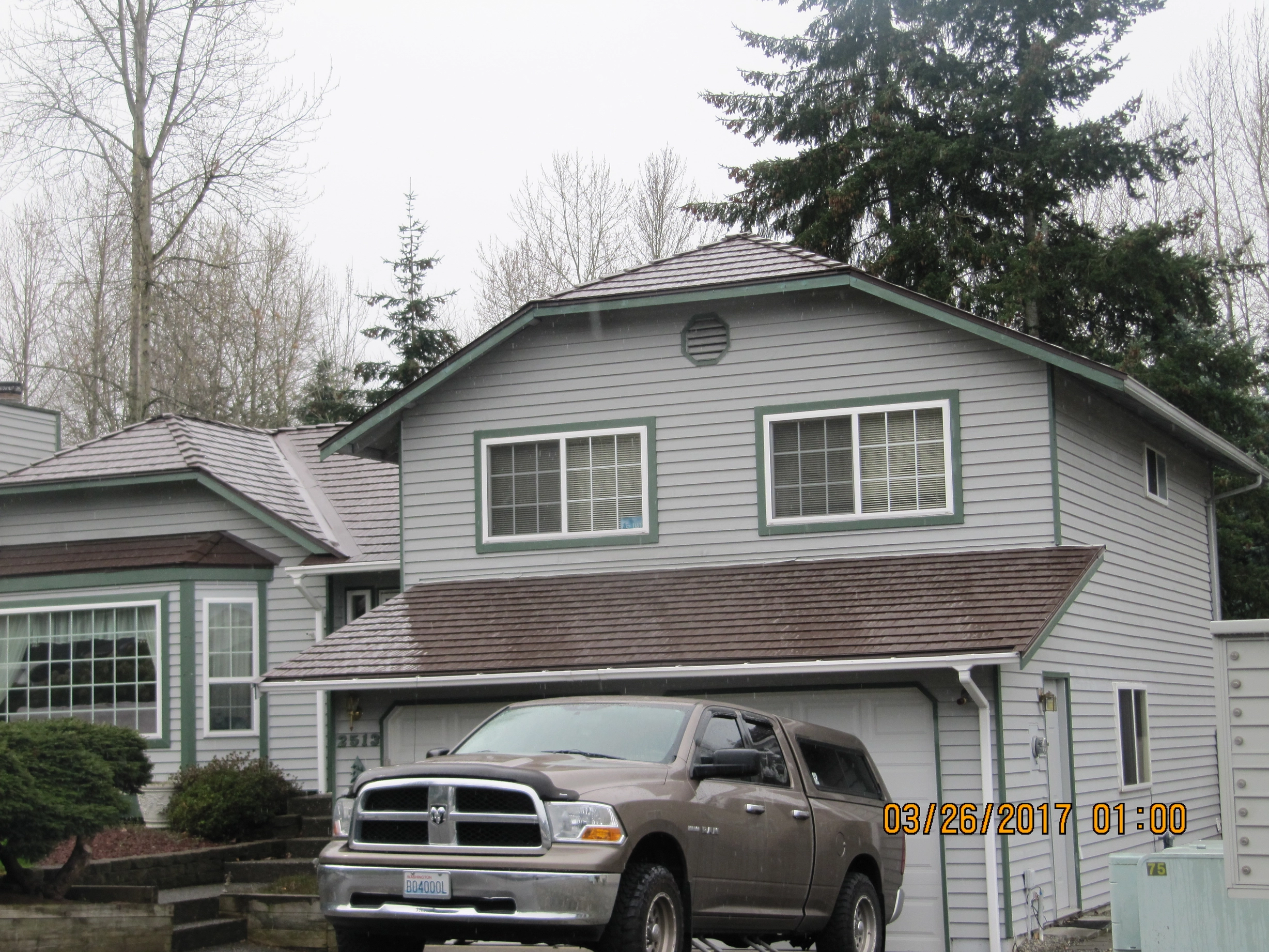 Colonial Brown Interlock Cedar Shingle aluminum roof on a Colonial brown metal roof on a two-storey grey home with, Renton, Washington