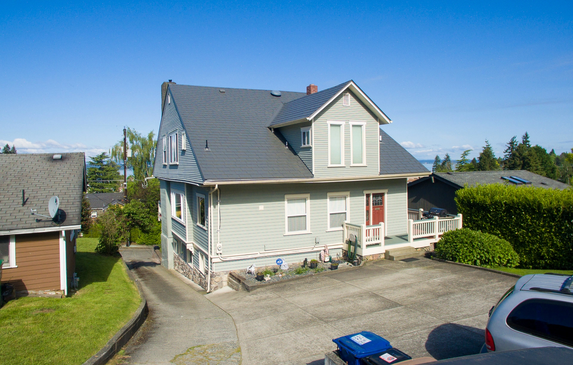Musket Grey Interlock Slate aluminum roof on a light green two-storey home with dormers in a suburban, Seattle, Washington