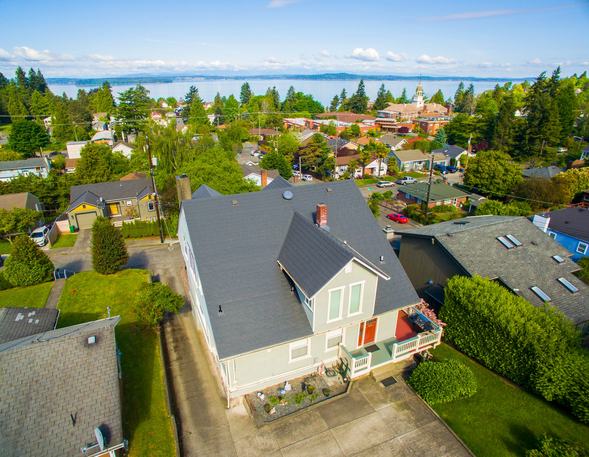 Musket Grey Interlock Slate aluminum roof on a two-storey cottage with dormers in a forested urban area, Seattle, Washington