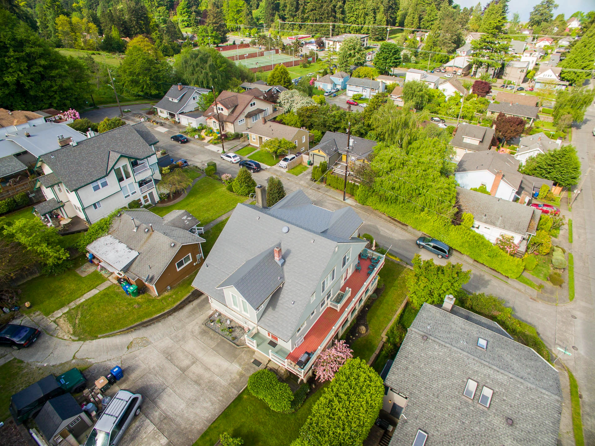 Musket Grey Interlock Slate aluminum roof on a two-storey home with dormers in a forested suburban, Seattle, Washington