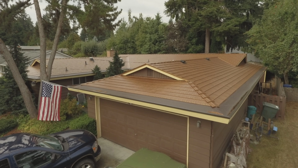 Aged Copper Interlock Cedar Shingle aluminum roof on a brown ranch home with a copper metal roof in a forested, Bellevue, Washington