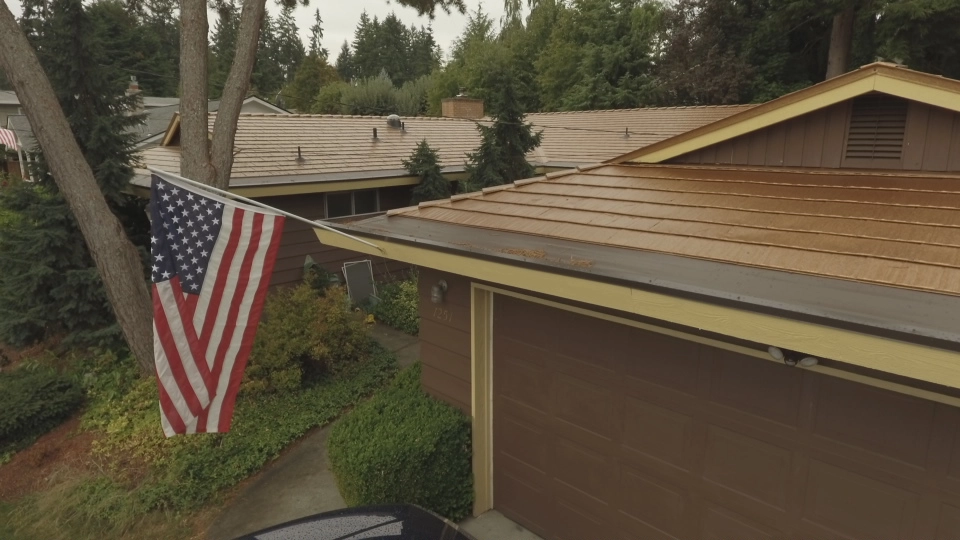 Aged Copper Interlock Cedar Shingle aluminum roof on a modern home with a metal roof in a forested urban setting, Bellevue, Washington