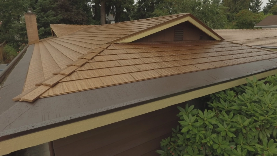 Aged Copper Interlock Cedar Shingle aluminum roof on a brown ranch style home with a copper metal roof in a, Bellevue, Washington