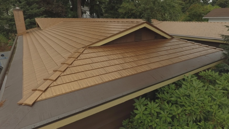 Aged Copper Interlock Cedar Shingle aluminum roof on a modern home with a metal roof among tall trees in the, Bellevue, Washington