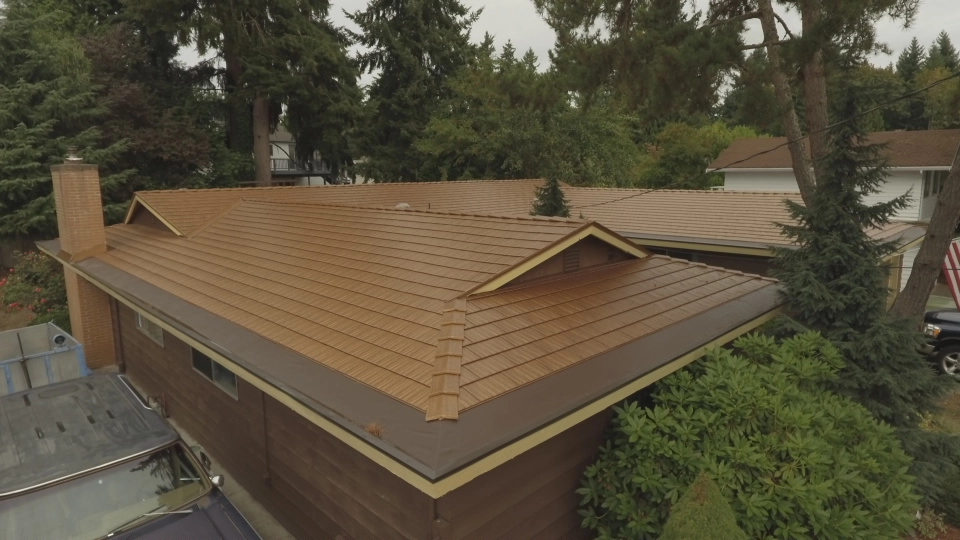 Aged Copper Interlock Cedar Shingle aluminum roof on a brown single-family ranch home with a cedar shingle metal, Bellevue, Washington