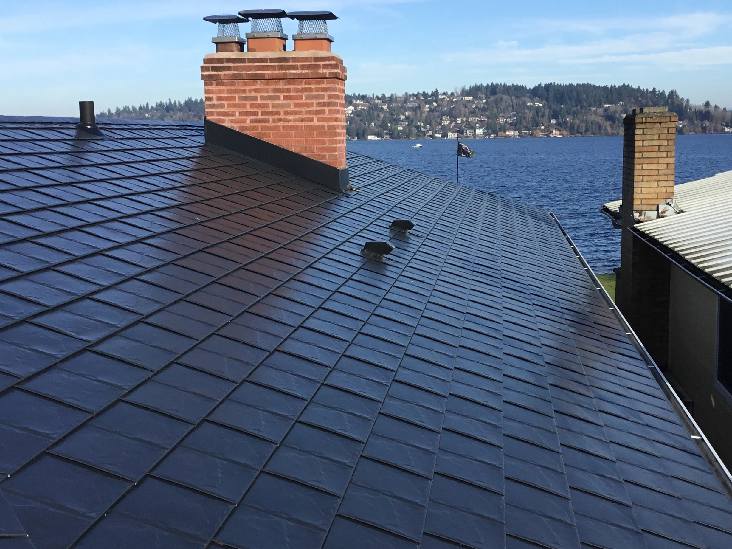 Black Interlock Slate aluminum roof on a black modern home with a metal roof overlooking the water, Seattle, Washington
