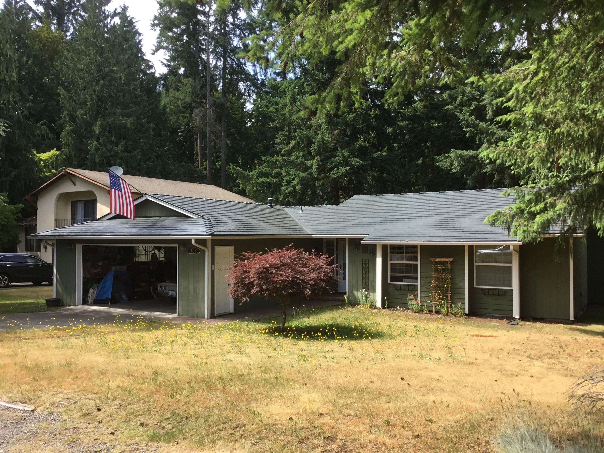 Deep Charcoal Interlock Slate aluminum roof on a two-storey home with a metal roof in a suburban forested, Renton, Washington