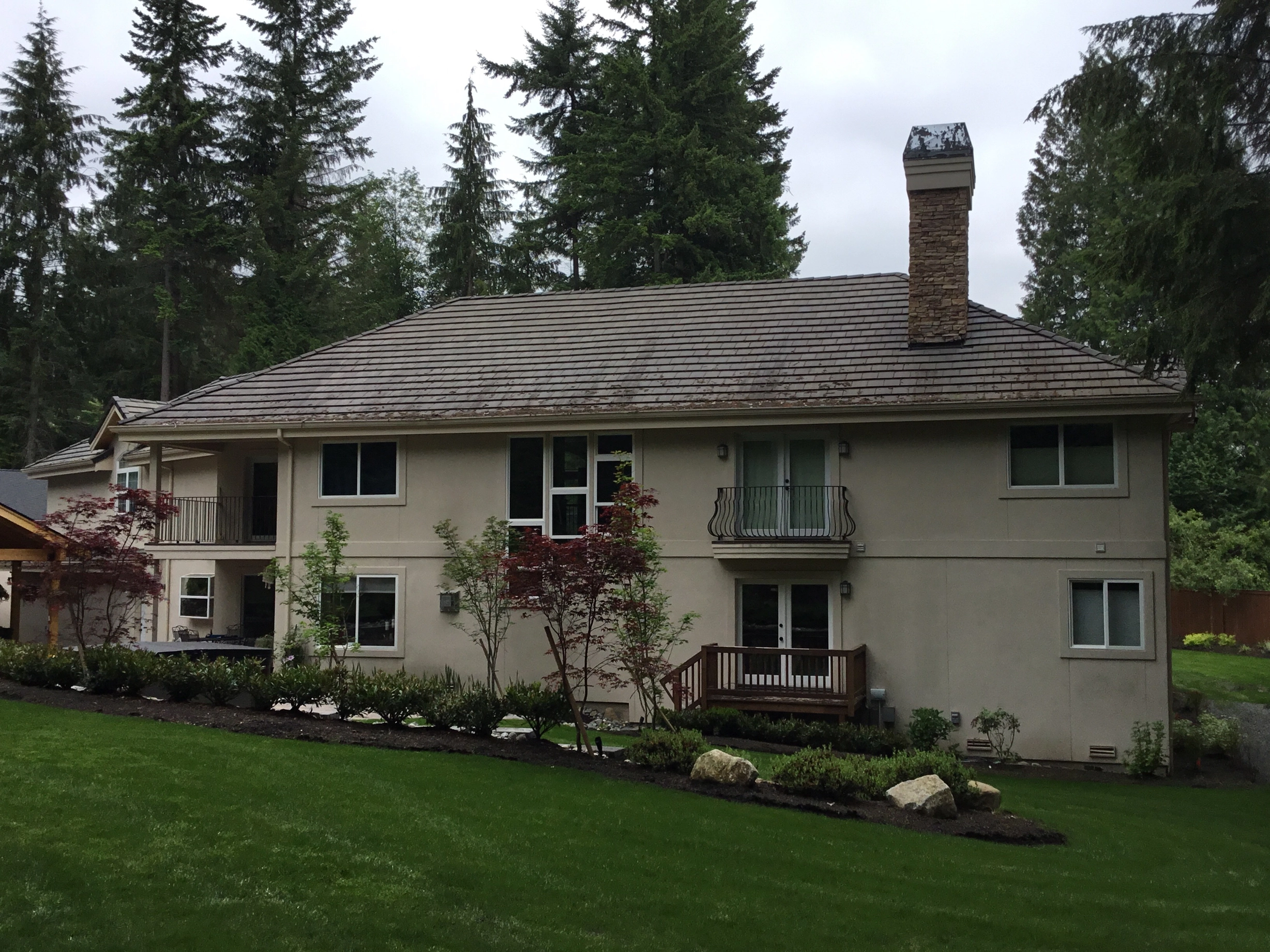 Before: a worn out concrete tile roof on the home, Bothell, Washington, ahead of a Black Interlock Slate aluminum roof