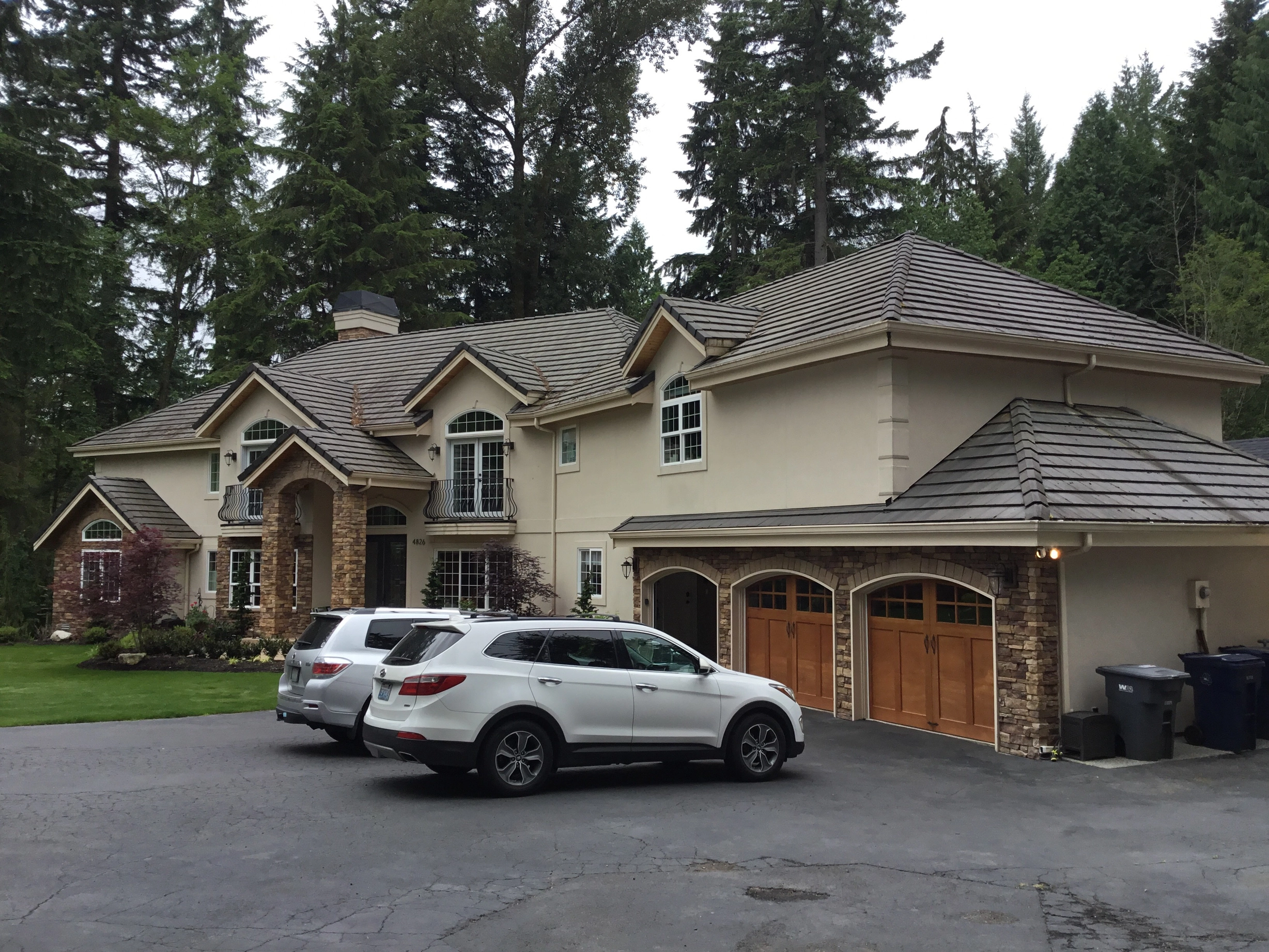 Before: a worn out concrete tile roof on the home, Bothell, Washington, ahead of a Black Interlock Slate aluminum roof