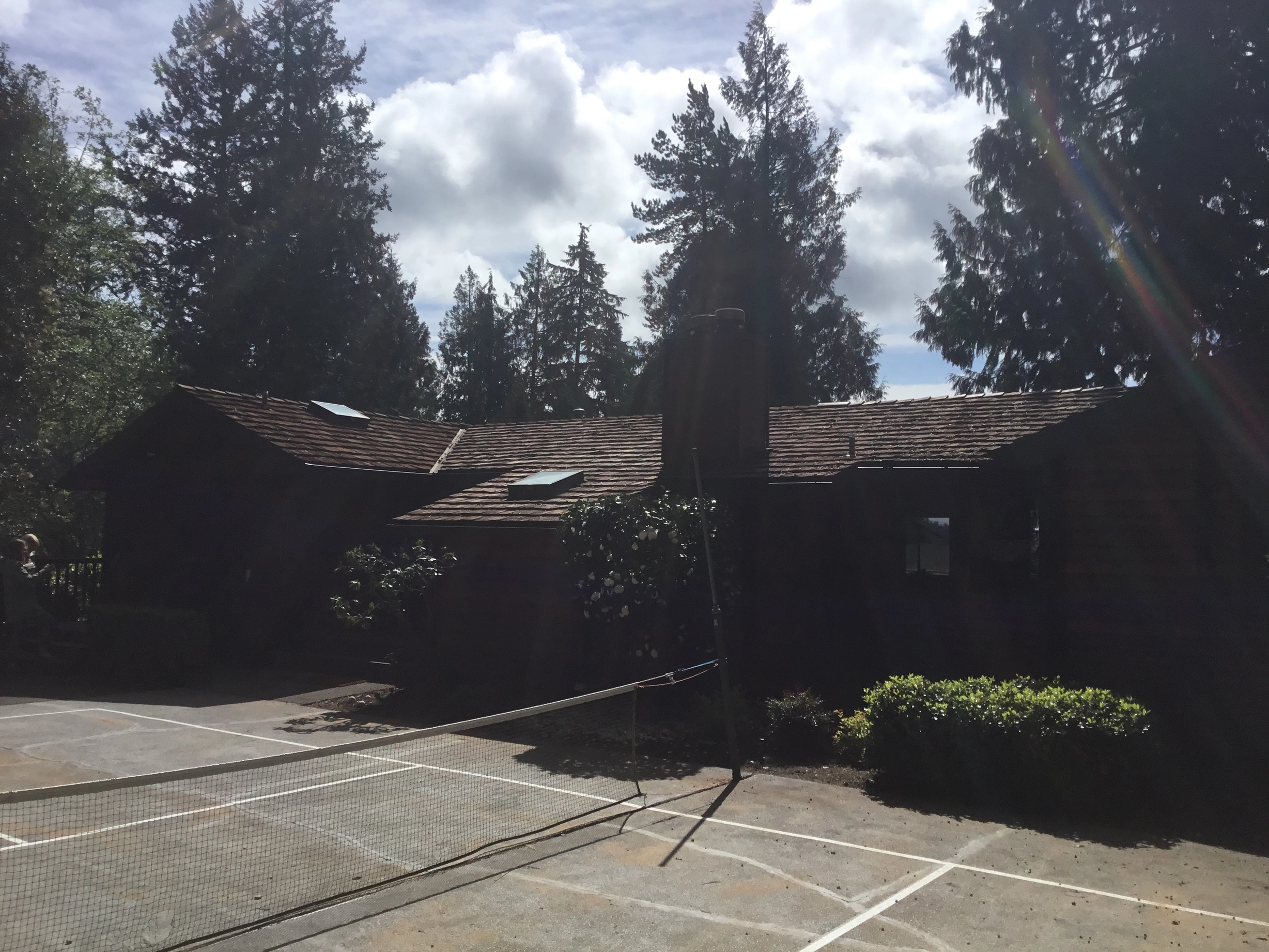 Before: a worn out wood shake roof on the home, Bainbridge Island, Washington, ahead of a Copper Penny Interlock Shake aluminum roof