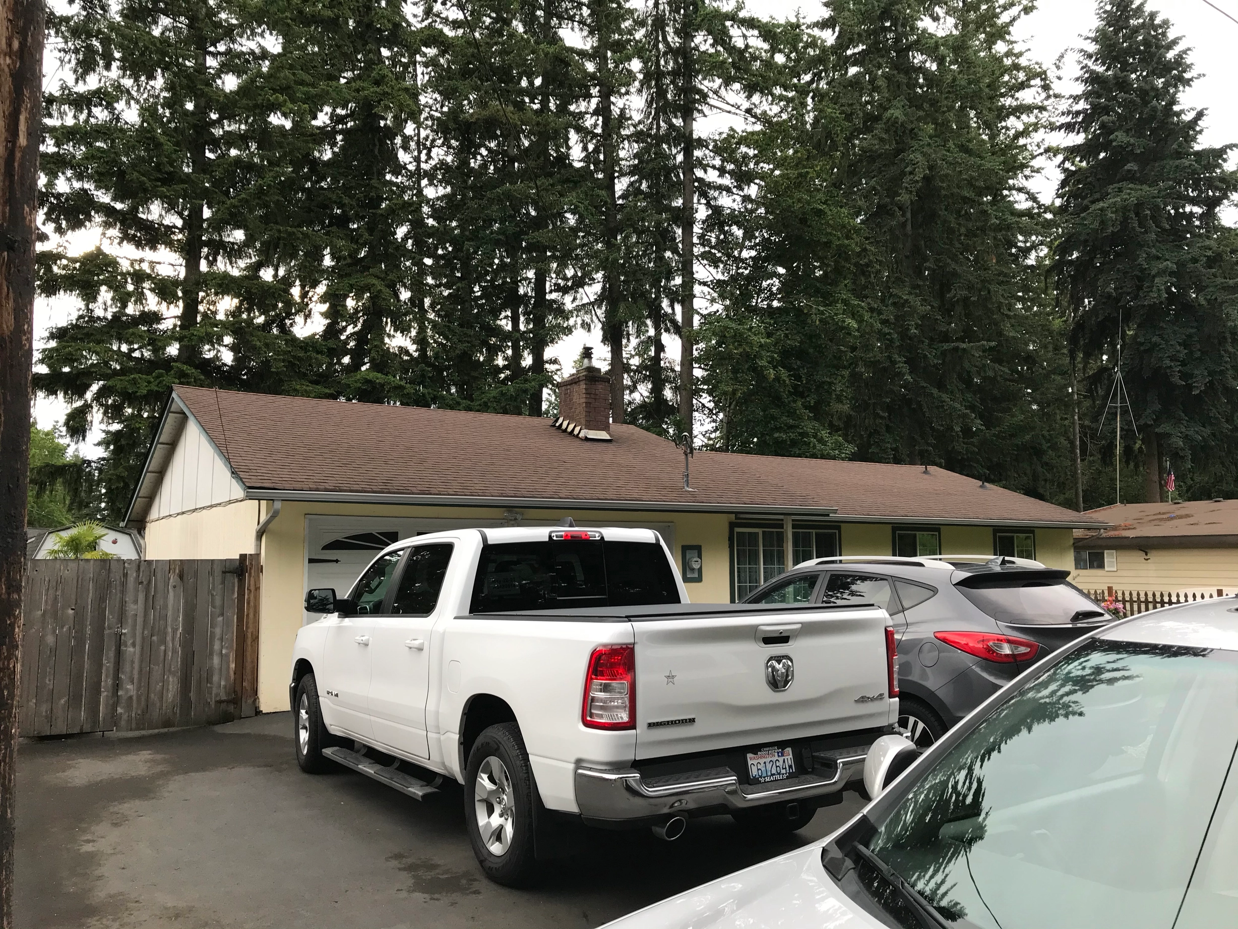 Before: a worn out asphalt shingle roof on the home, Kent, Washington, ahead of a Deep Charcoal Interlock Shake aluminum roof