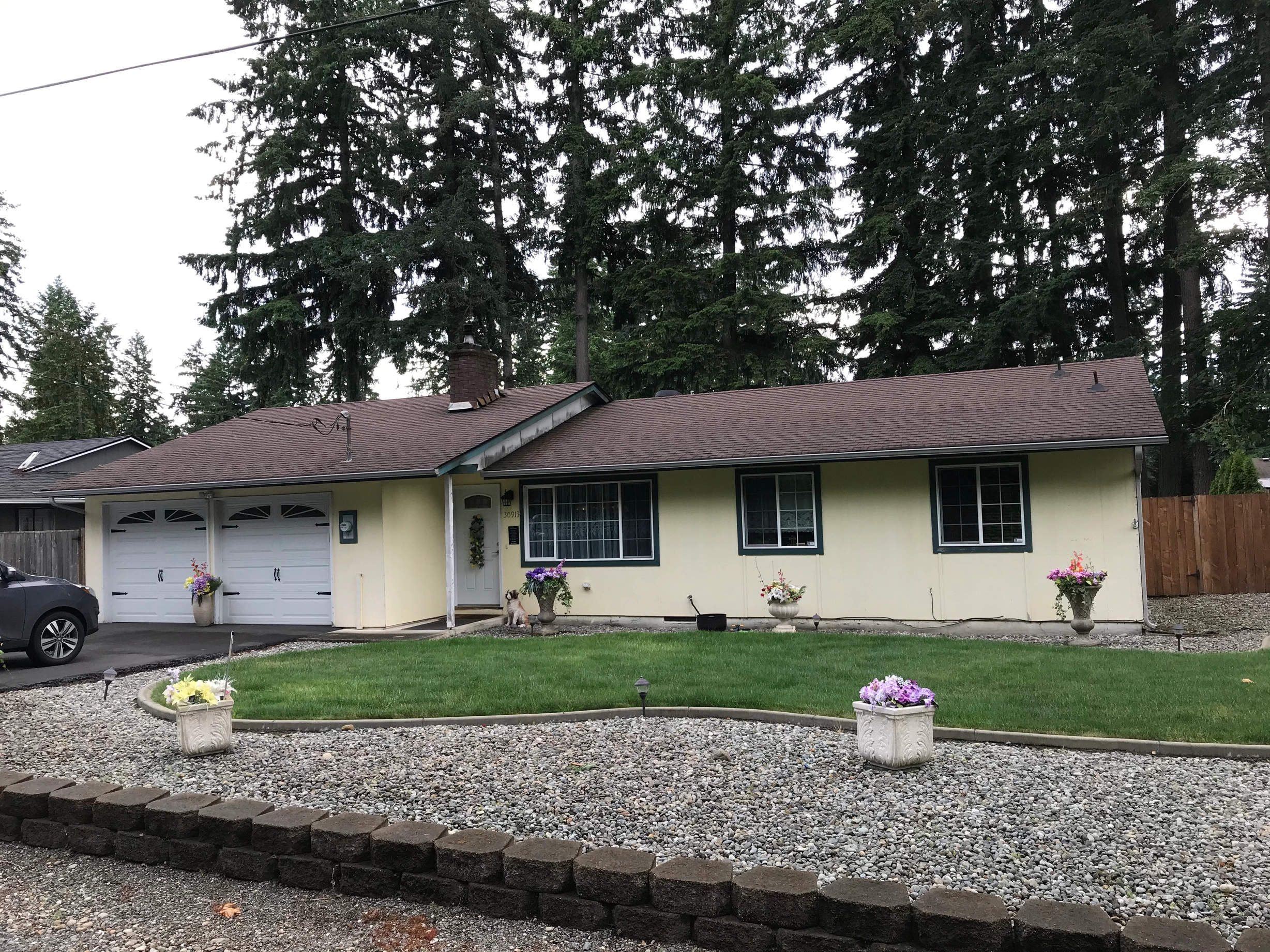 Before: a worn out asphalt shingle roof on the home, Kent, Washington, ahead of a Deep Charcoal Interlock Shake aluminum roof