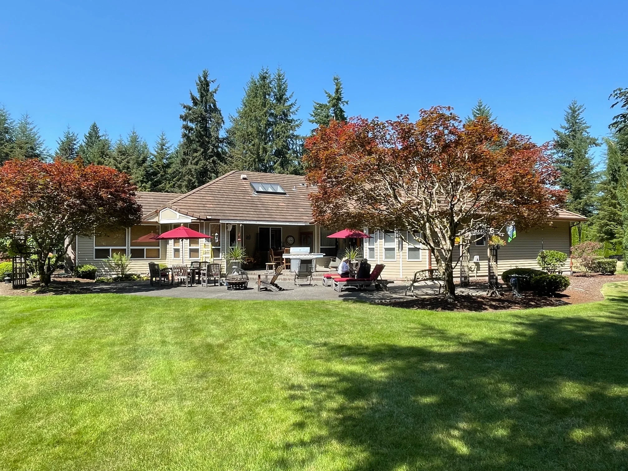 Before: a concrete tile roof with broken tiles on the home, Auburn, Washington, ahead of a Copper Penny Interlock Shake aluminum roof