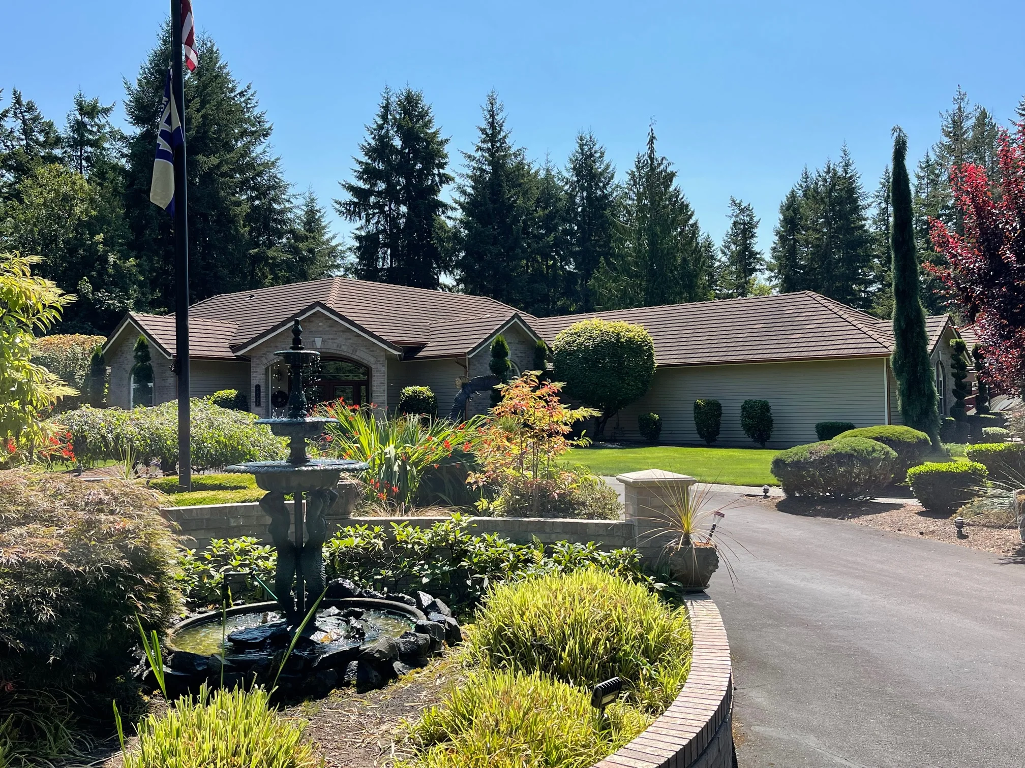 Before: a concrete tile roof with broken tiles on the home, Auburn, Washington, ahead of a Copper Penny Interlock Shake aluminum roof