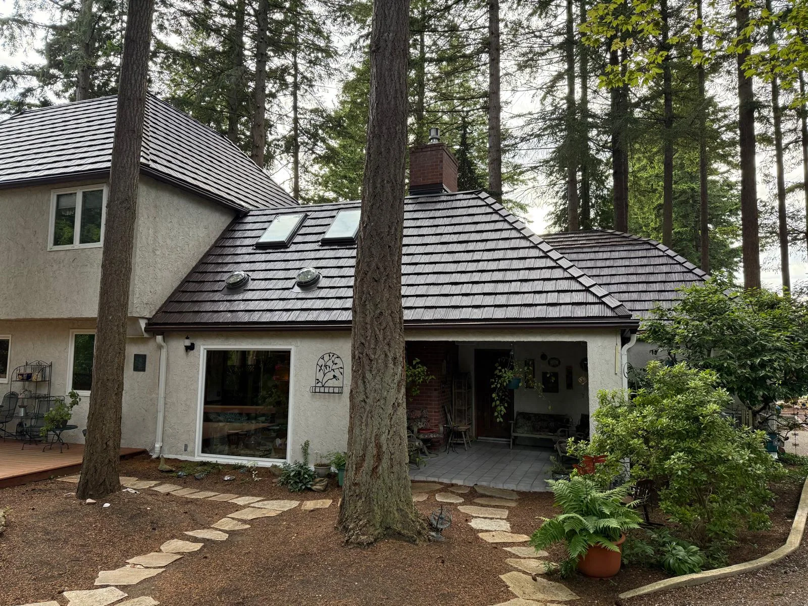 Colonial Brown Interlock Shake aluminum roof on a colonial-style home with a metal roof being installed in, Bellingham, Washington