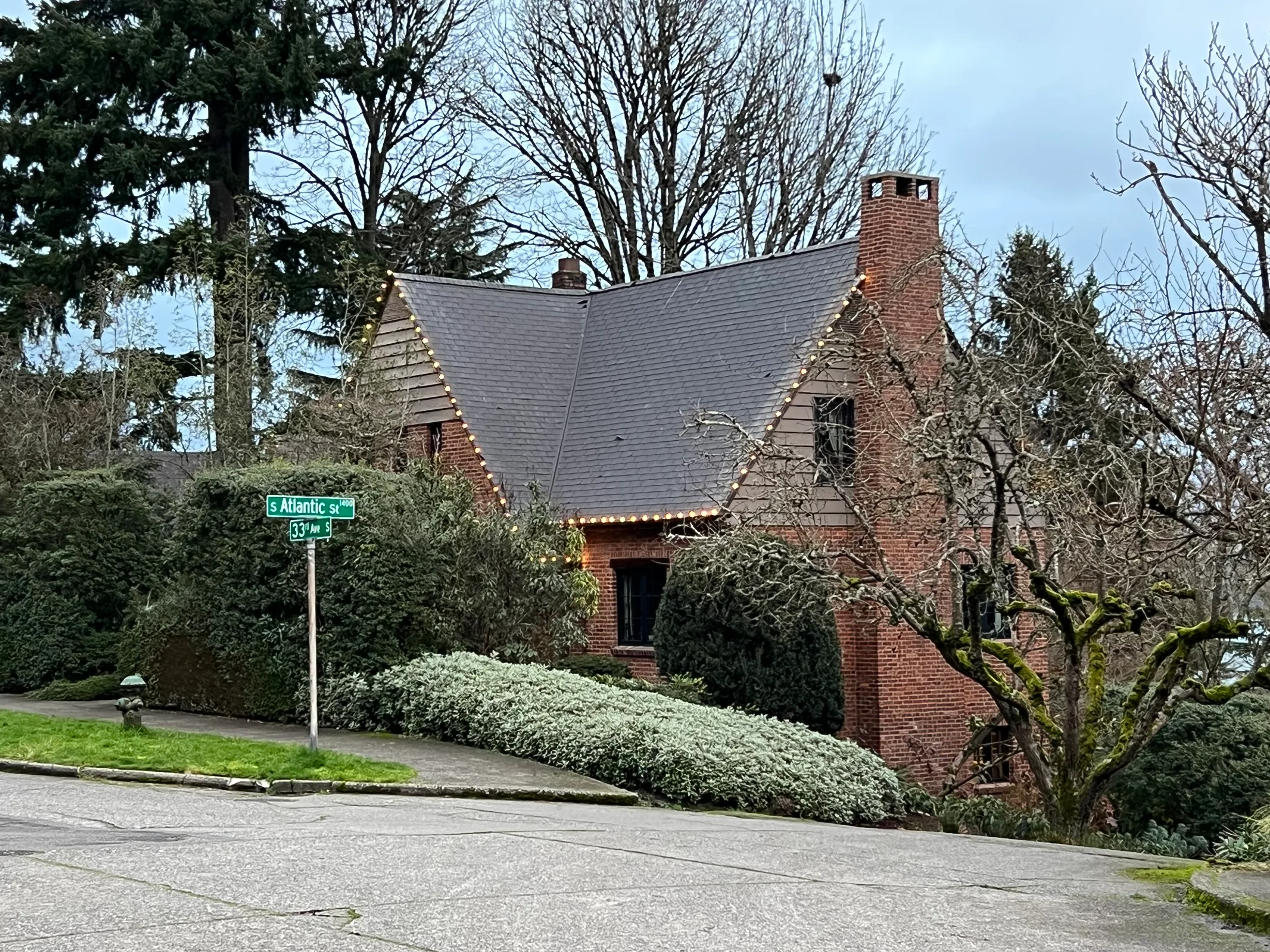 Deep Charcoal Interlock Slate aluminum roof on a two-storey home with a metal roof in a forested urban, Seattle, Washington