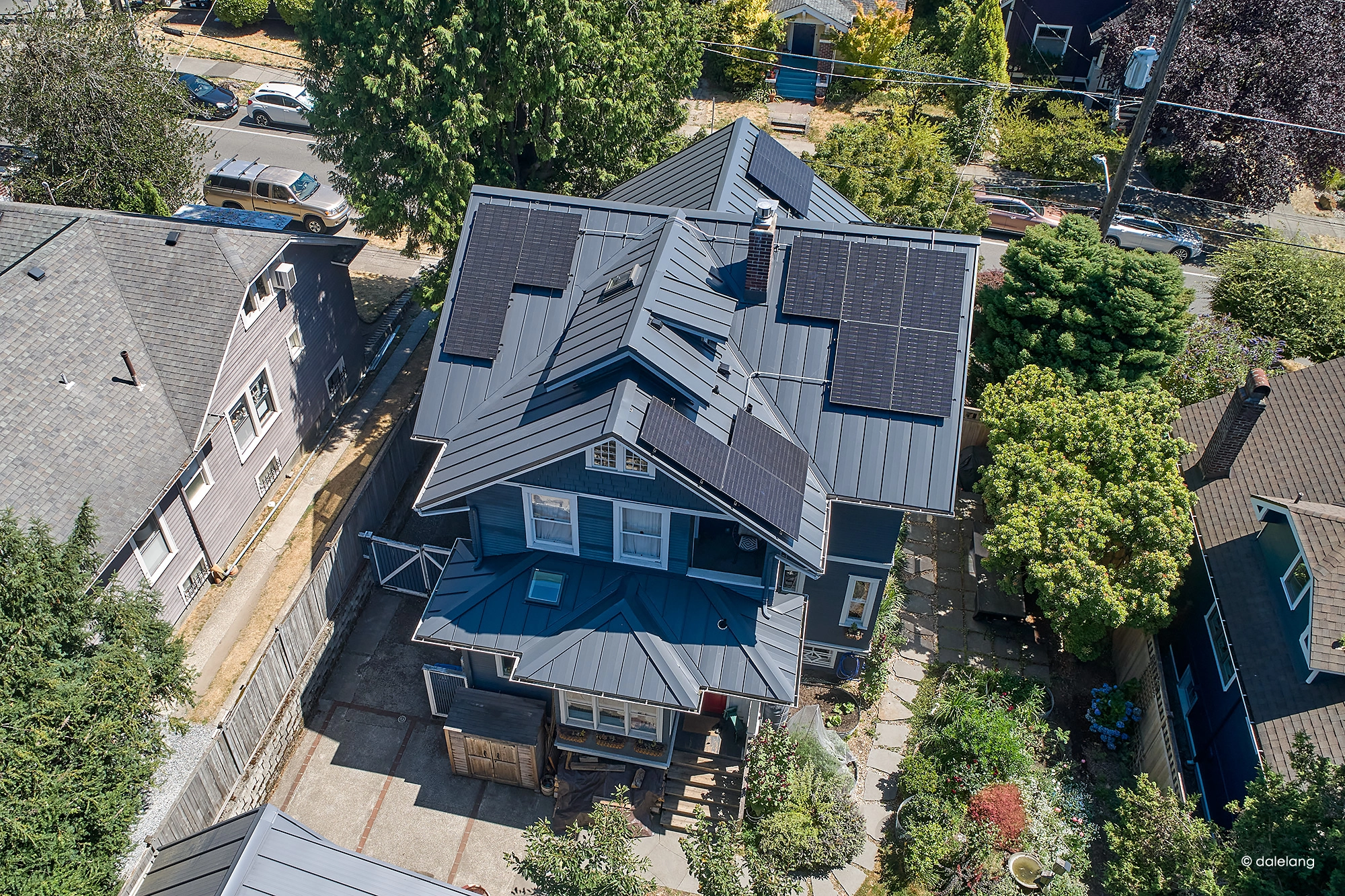 Deep Charcoal Interlock Standing Seam aluminum roof on a two-storey home with dormers in an urban setting, Seattle, Washington