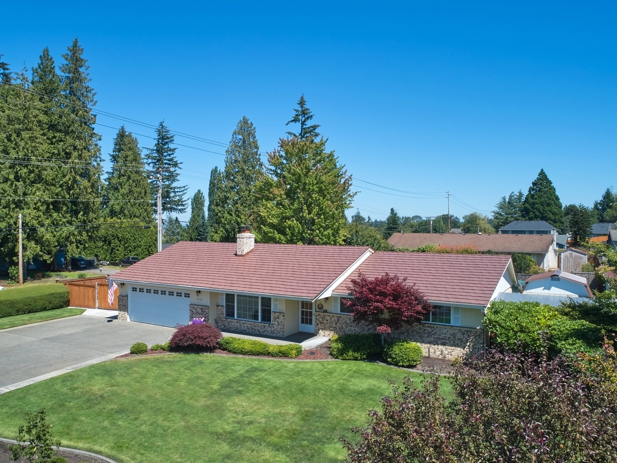 Aged Copper Interlock Shake aluminum roof on a house with an aged copper metal roof in a suburban, Puyallup, Washington
