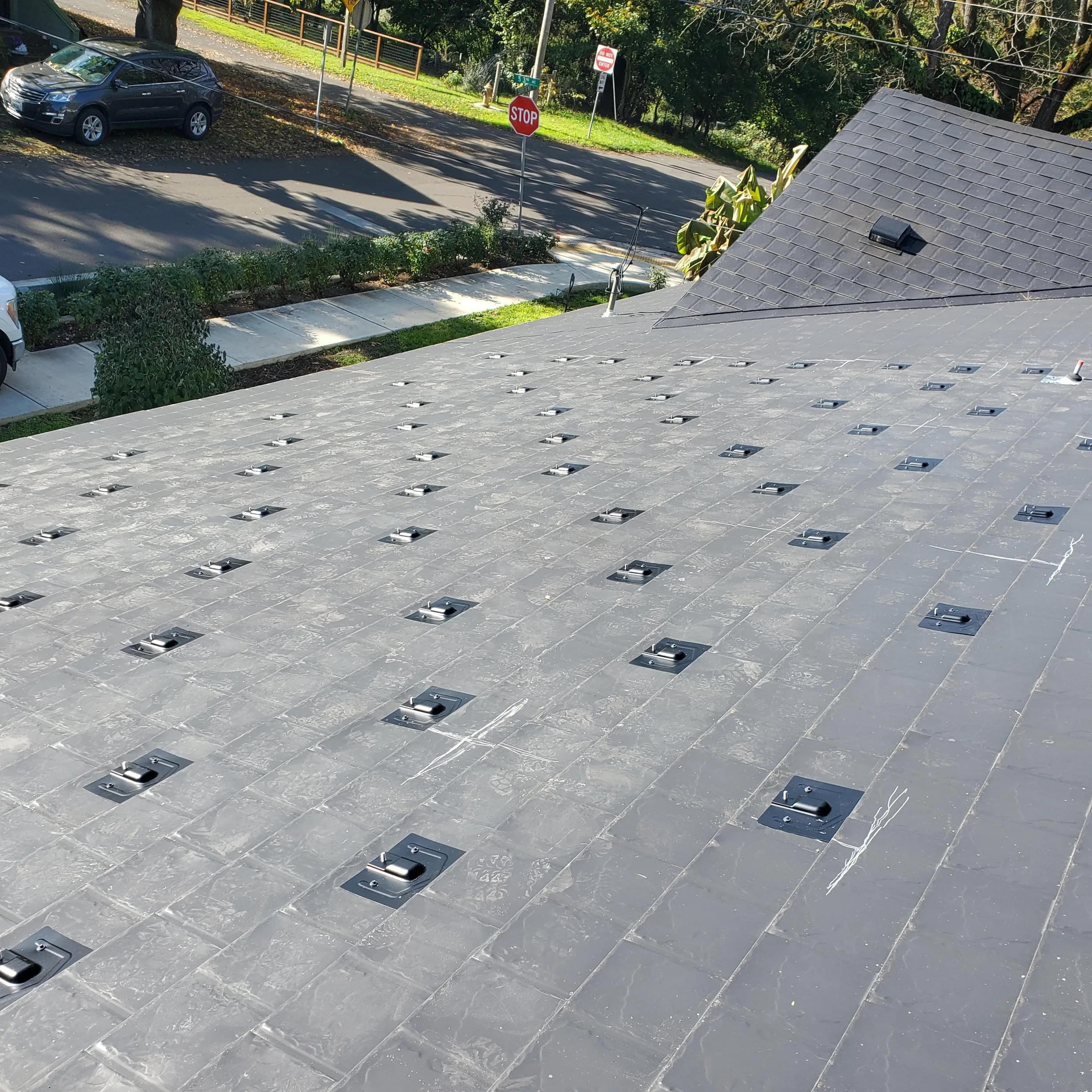 Black Interlock Slate aluminum roof on a modern home with a black metal roof in an urban setting, Ridgefield, Washington