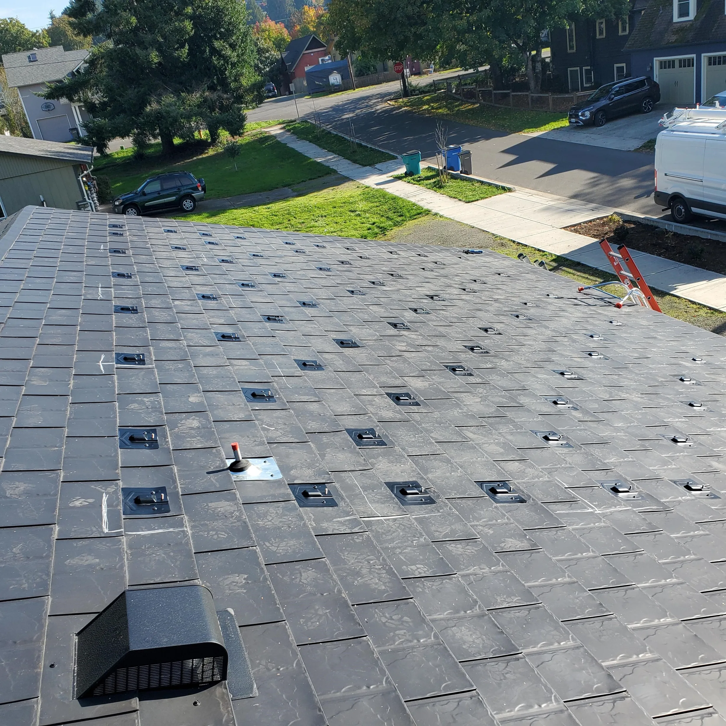 Black Interlock Slate aluminum roof being installed on the home, replacing a worn out asphalt shingle roof, Ridgefield, Washington