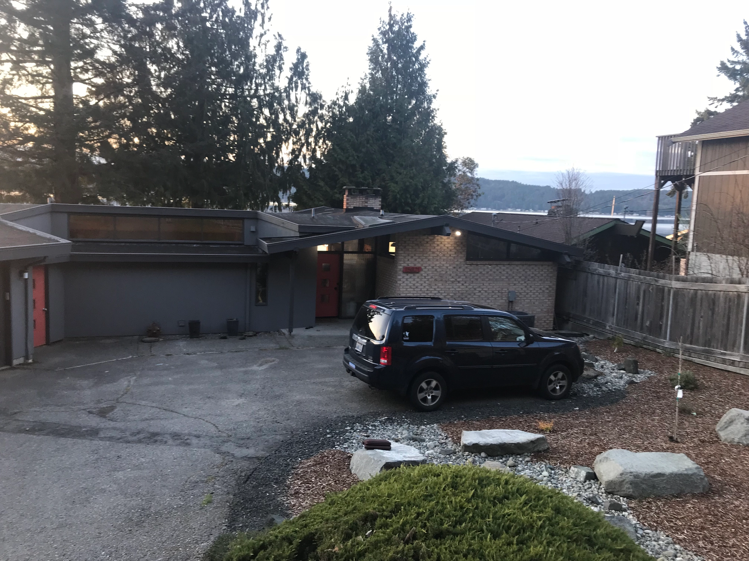 Before: the old roof on the home, Belfair, Washington, ahead of a Musket Grey Interlock Standing Seam aluminum roof